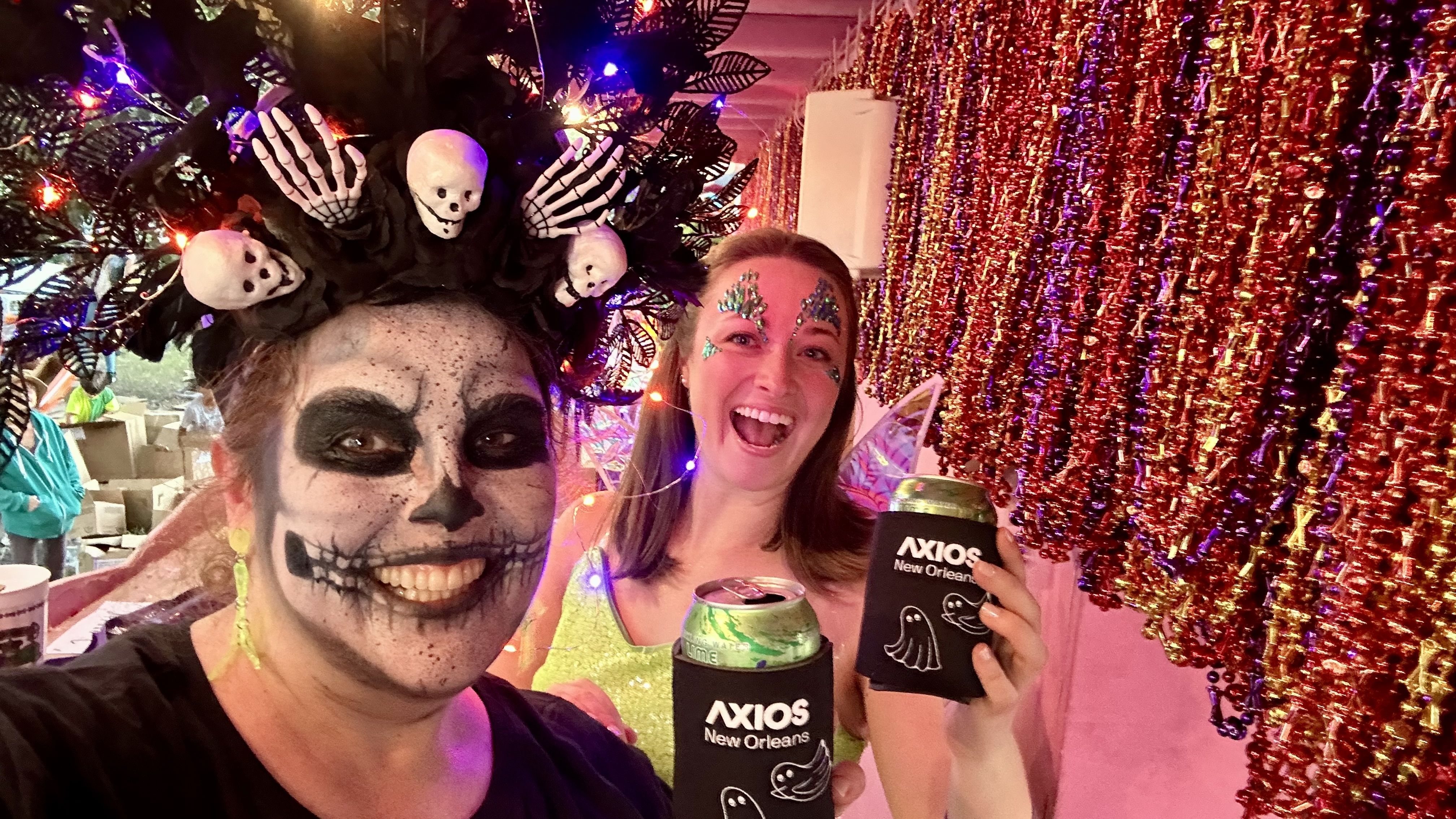 Photo shows Carlie and Maddy with Axios New Orleans koozies.