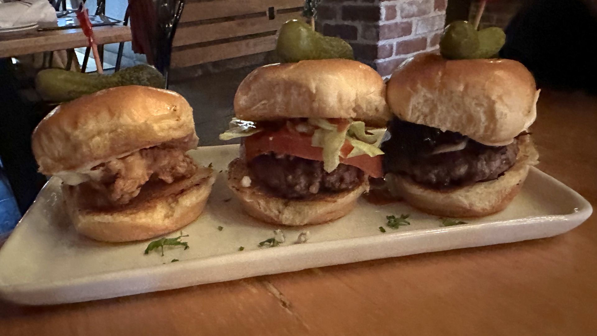 A photo of three sliders on a long plate.