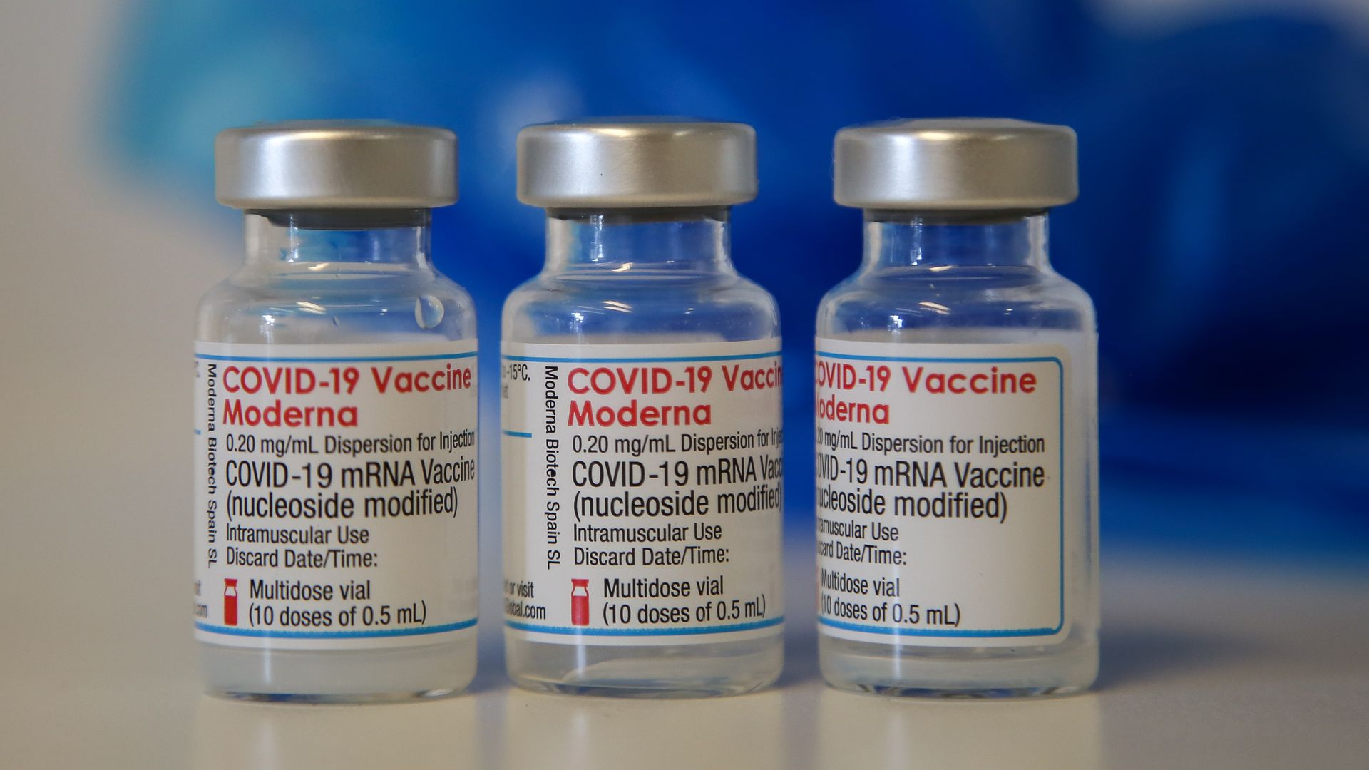 Three moderna vaccine vials