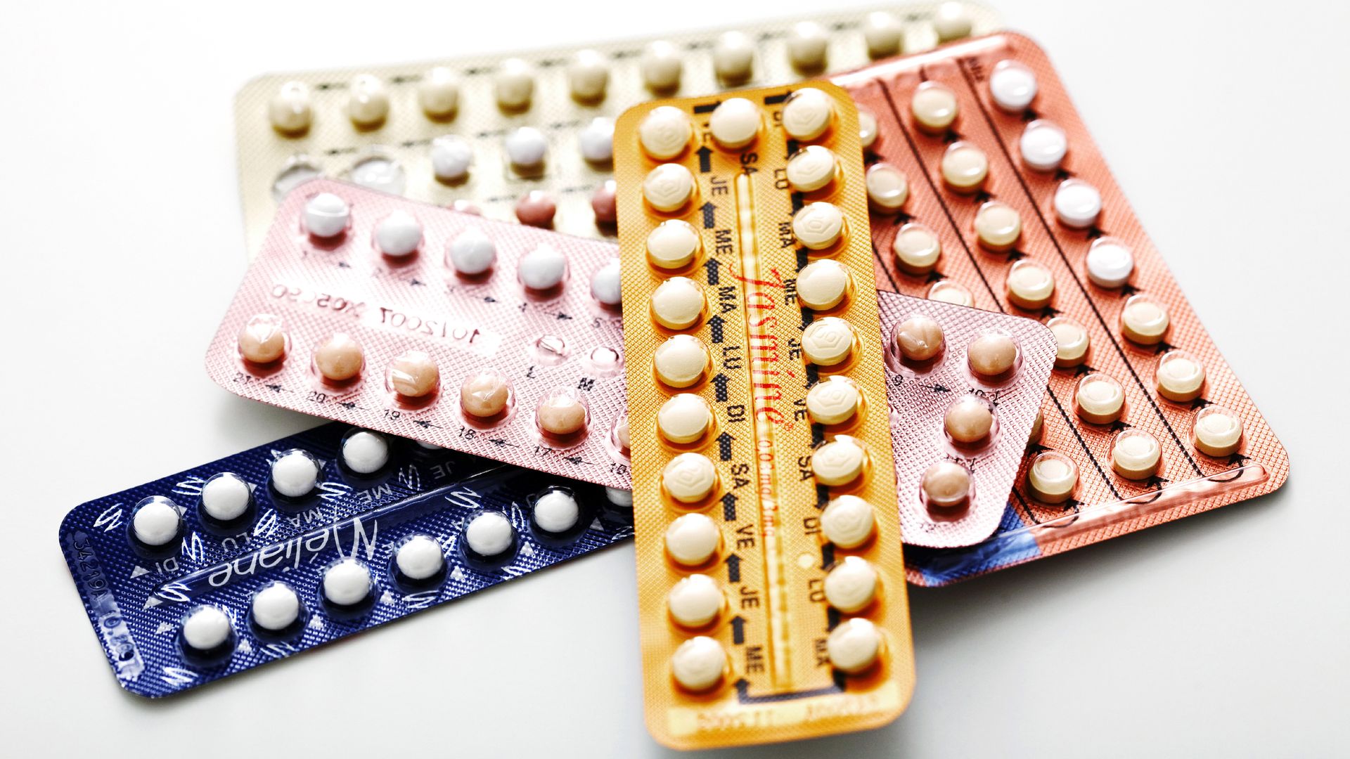 Birth control pills in multicolors in a stack.