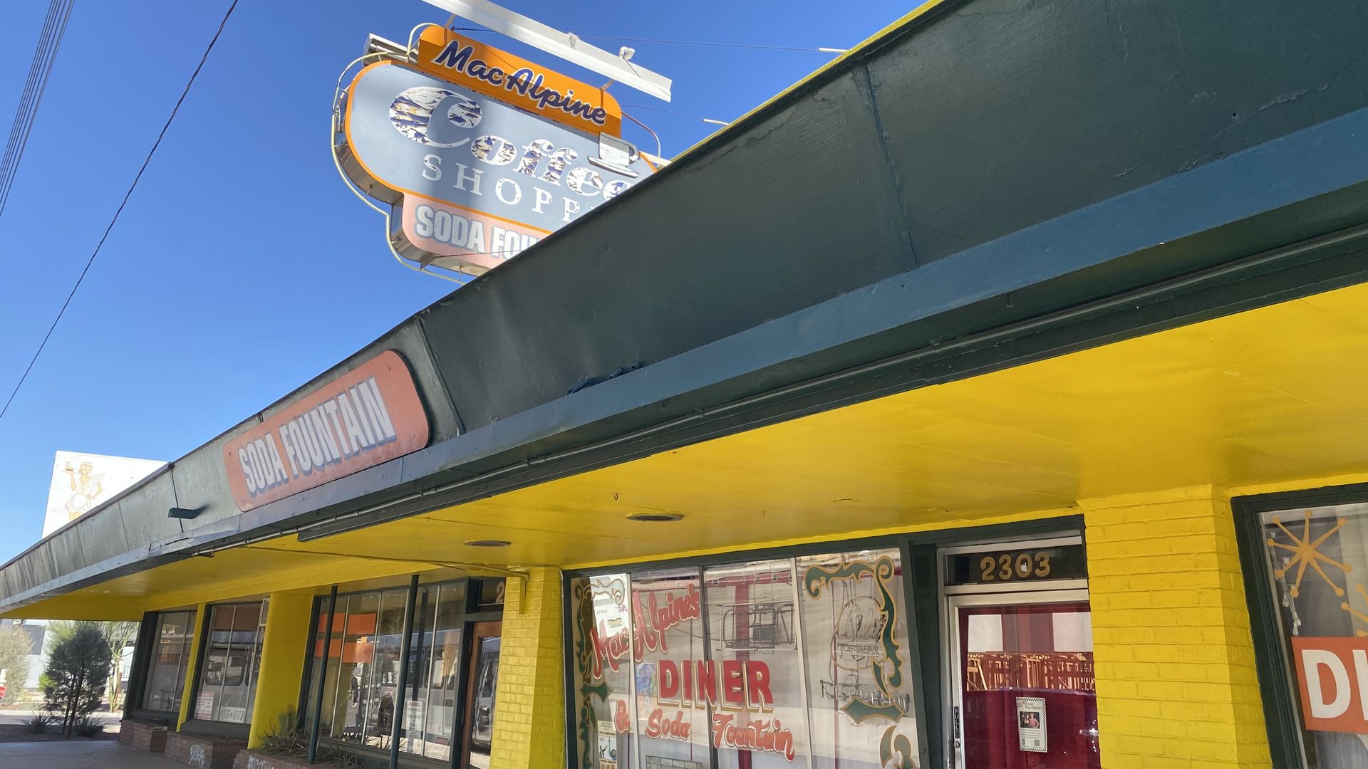 The front of a restaurant with a sign above the roof that says MacAlpine's.