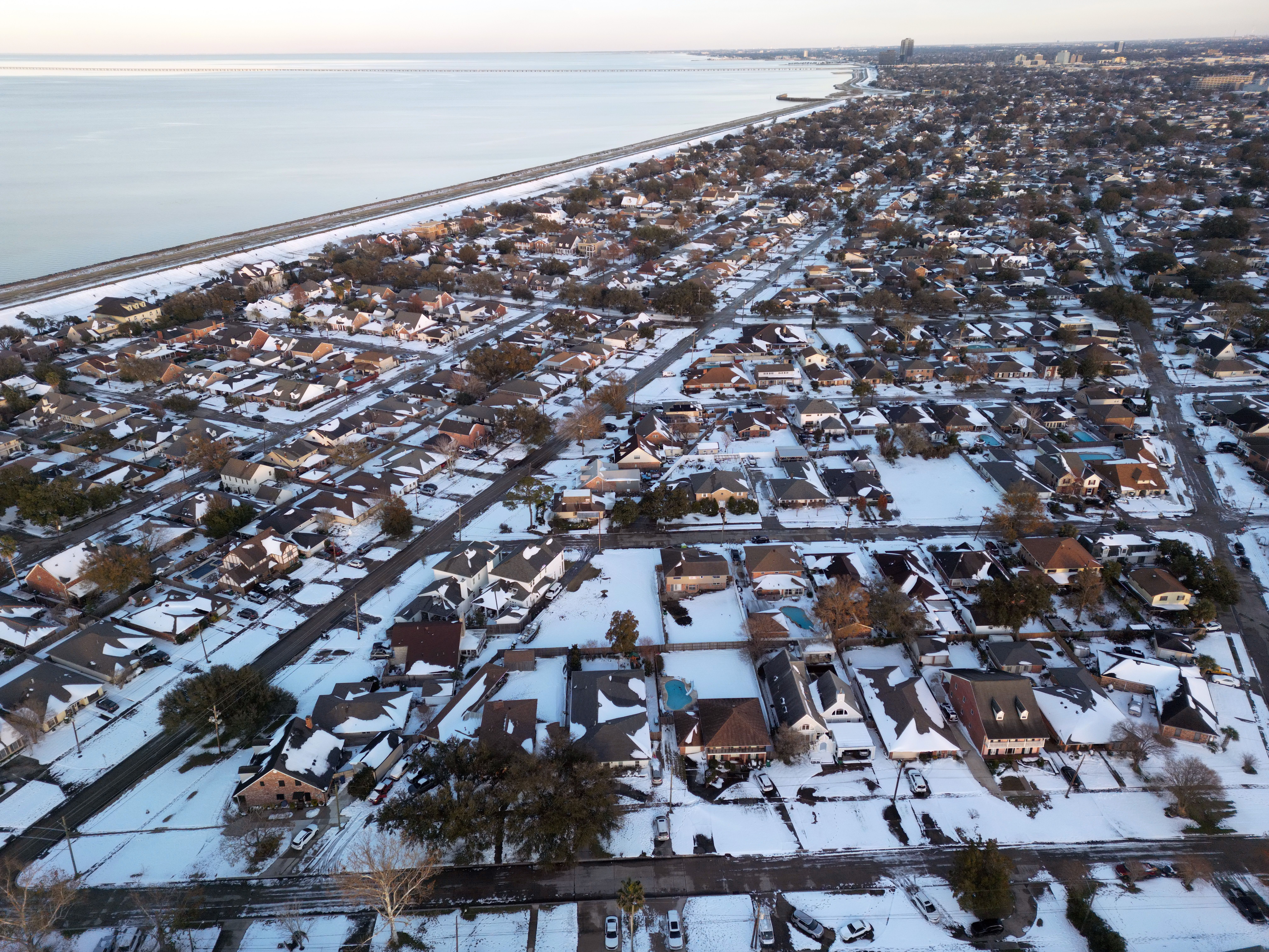Photo shows an aerial view of Metairie homes in the snow.