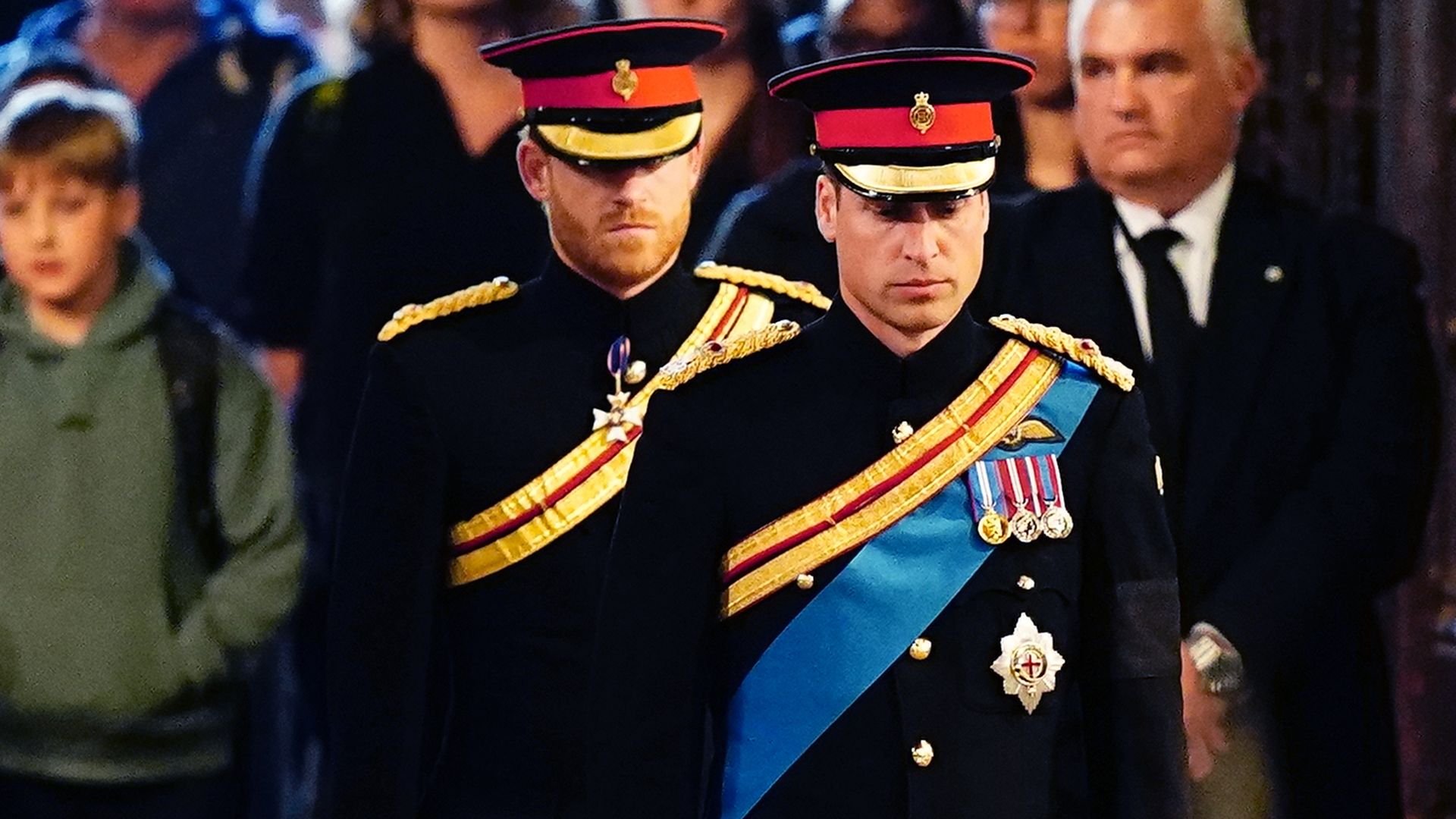 Prince William, Prince of Wales, and Prince Harry, Duke of Sussex, arrive in military uniforms to hold a vigil for their grandmother, Queen Elizabeth II. 