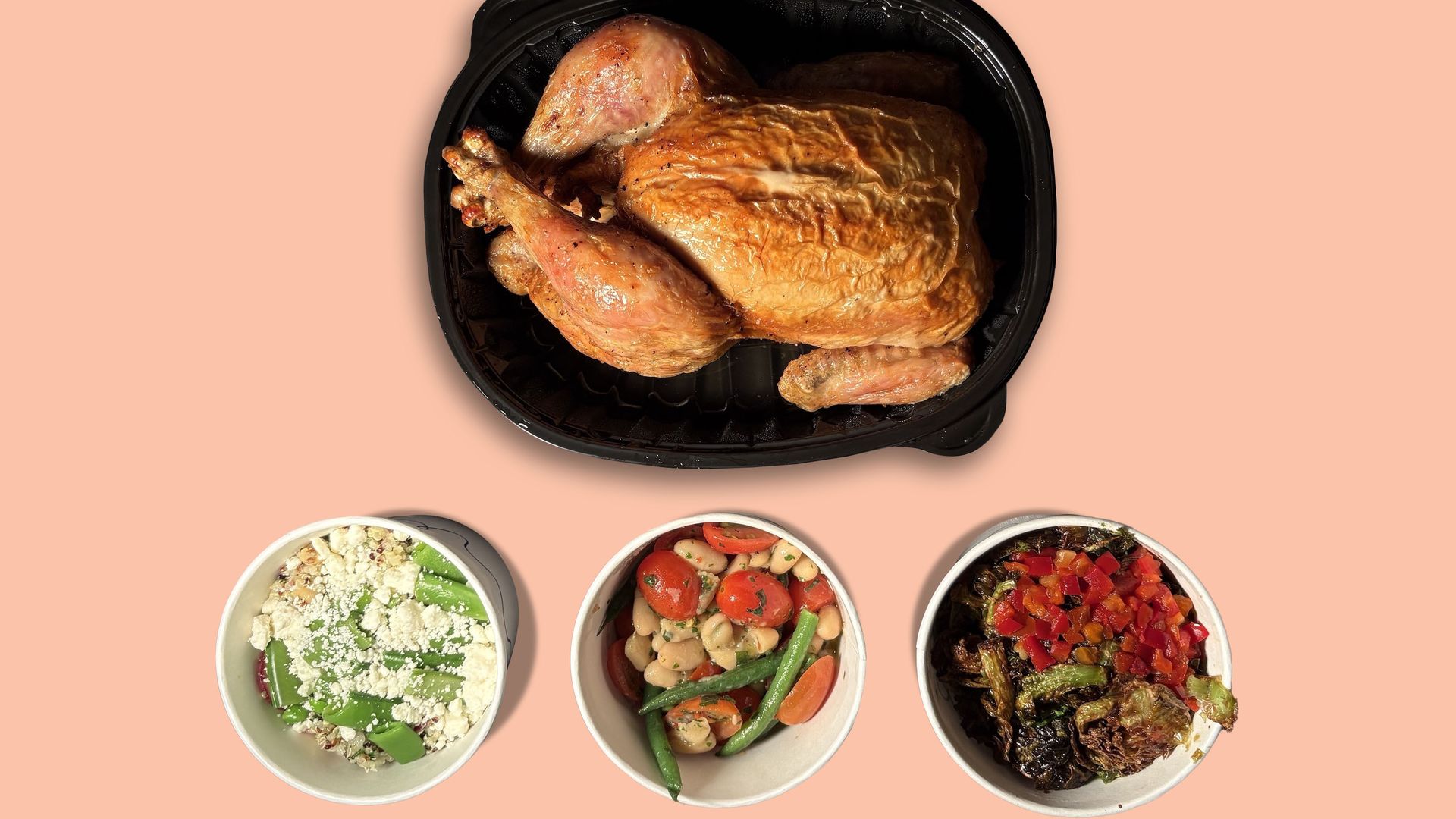 Rotisserie chicken in a black carton with three circular sides underneath: quinoa salad, green bean salad, and Brussels