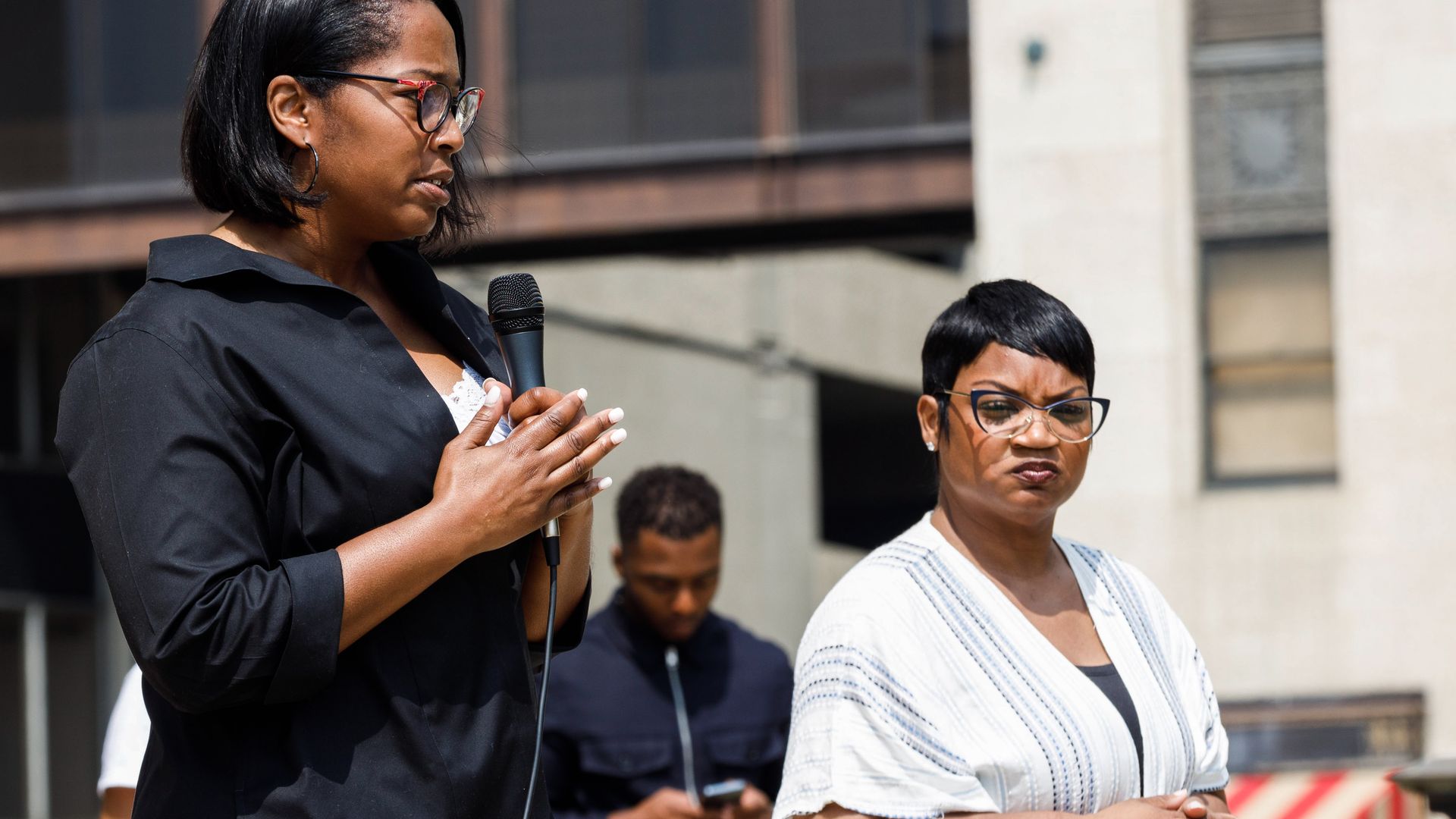Columbus Police Chief Elaine Bryant and Assistant Chief LaShanna Potts are seen at a rally, with Bryant speaking into a microphone.