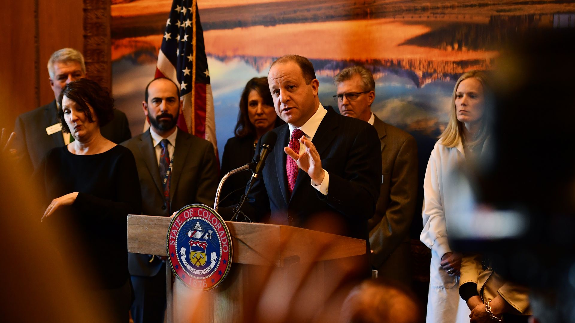Mike Willis stands over Gov. Jared Polis' left shoulder as the governor announces a state of emergency in March 2020 due to COVID-19. Photo: Hyoung Chang/The Denver Post via Getty Images