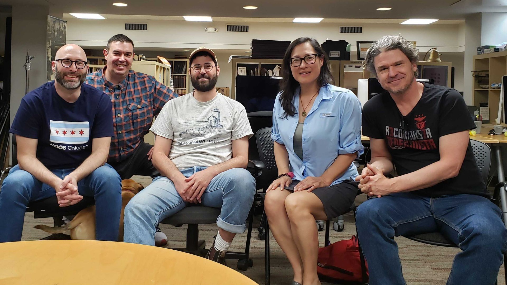 Justin Kaufmann, Jordan Dziura of Illini Media, Daniel Gumbiner of The Believer, Monica Eng and Dave Eggers smile while seated in chairs in a University of Illinois classroom.