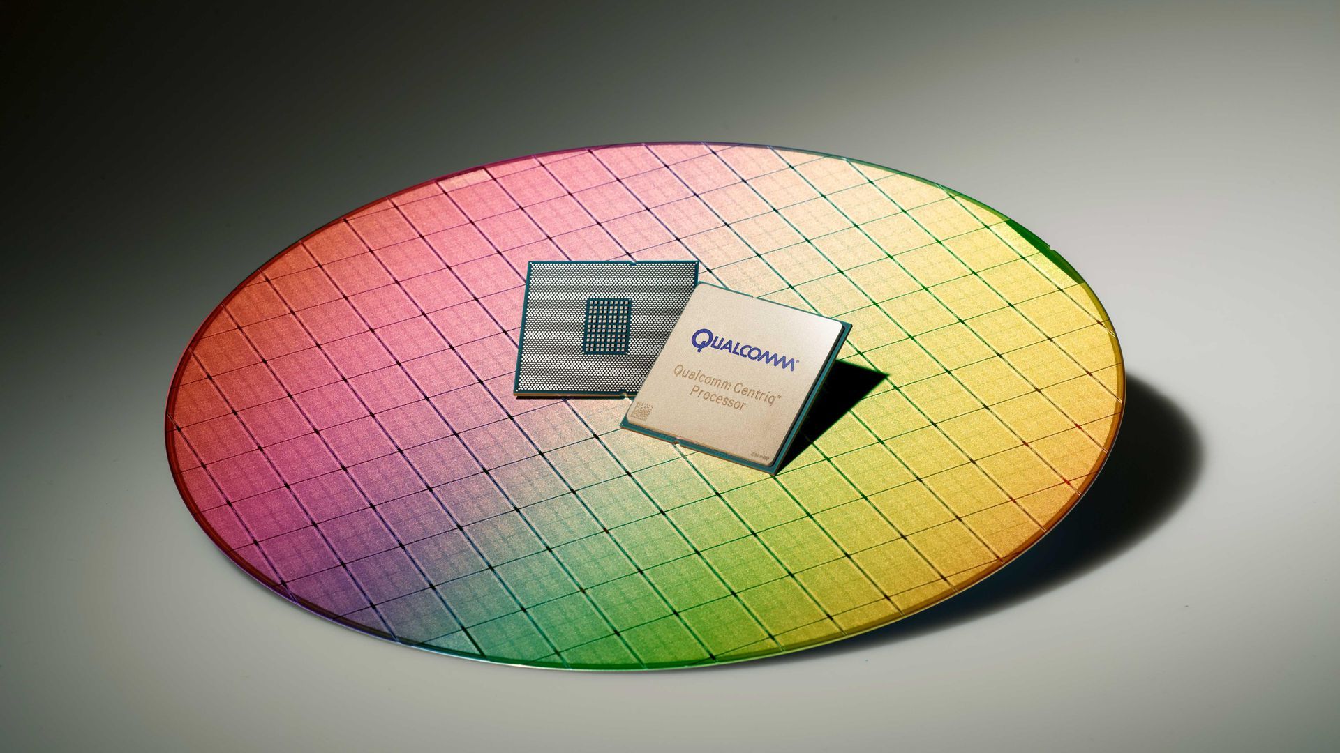 A pair of Qualcomm chips on a chip wafer