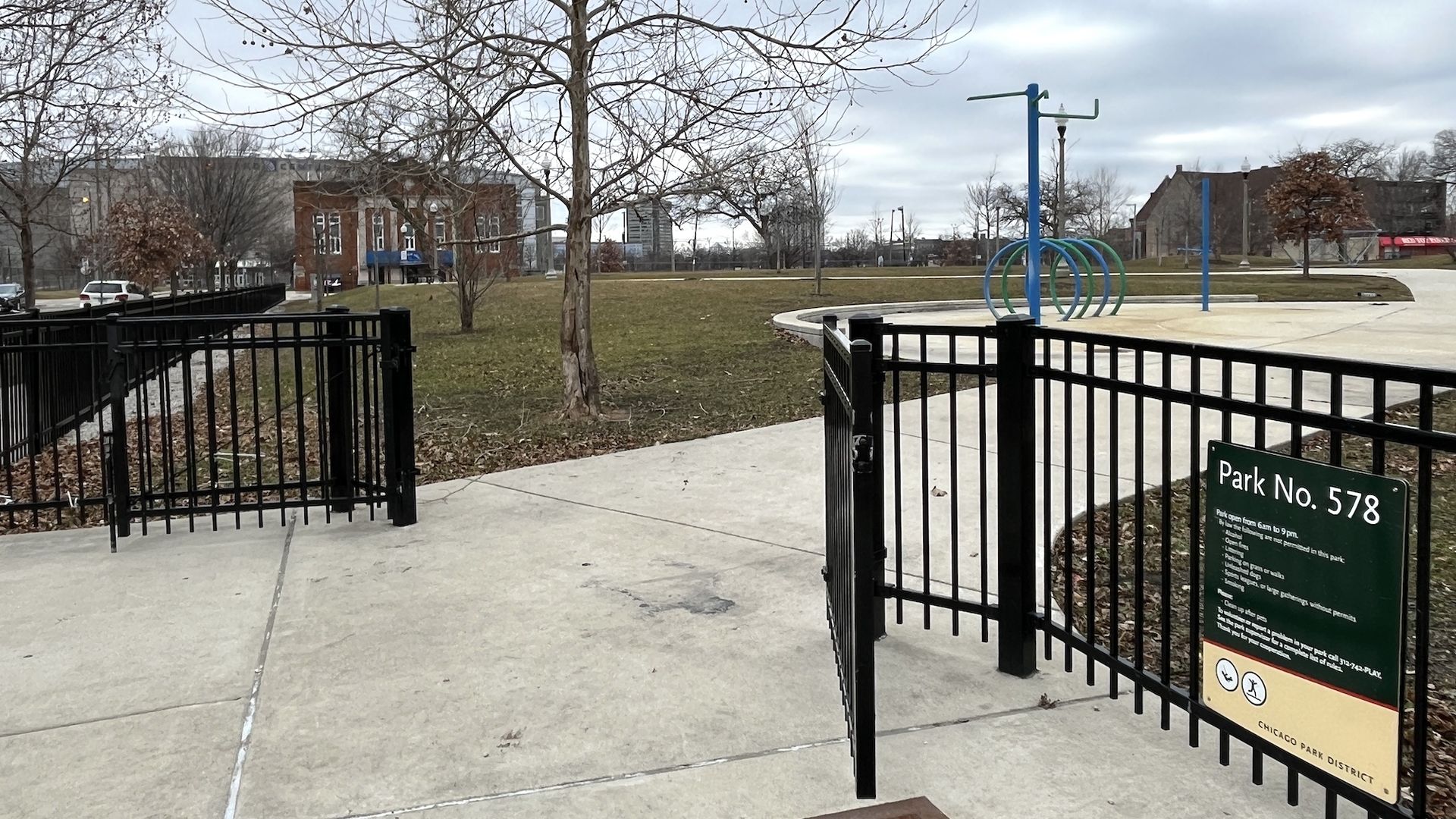 The open gates to a playground with a green sign that reads Park No. 578