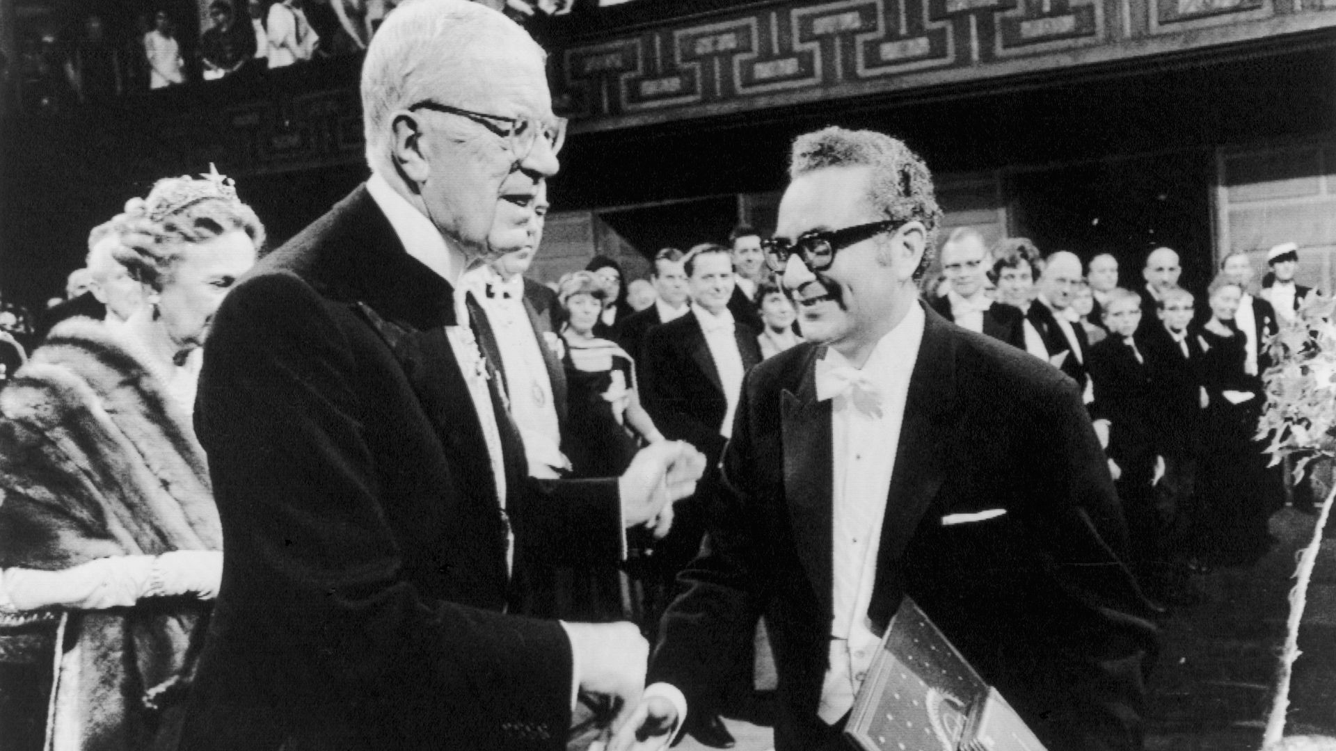 Black and white photo of two men shaking hands