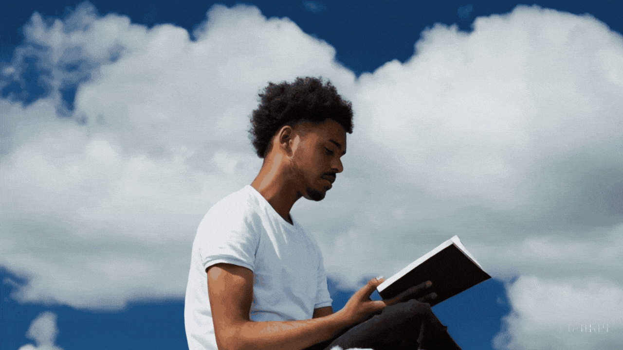 An image generated by Sora that shows a man sitting on a cloud reading a book