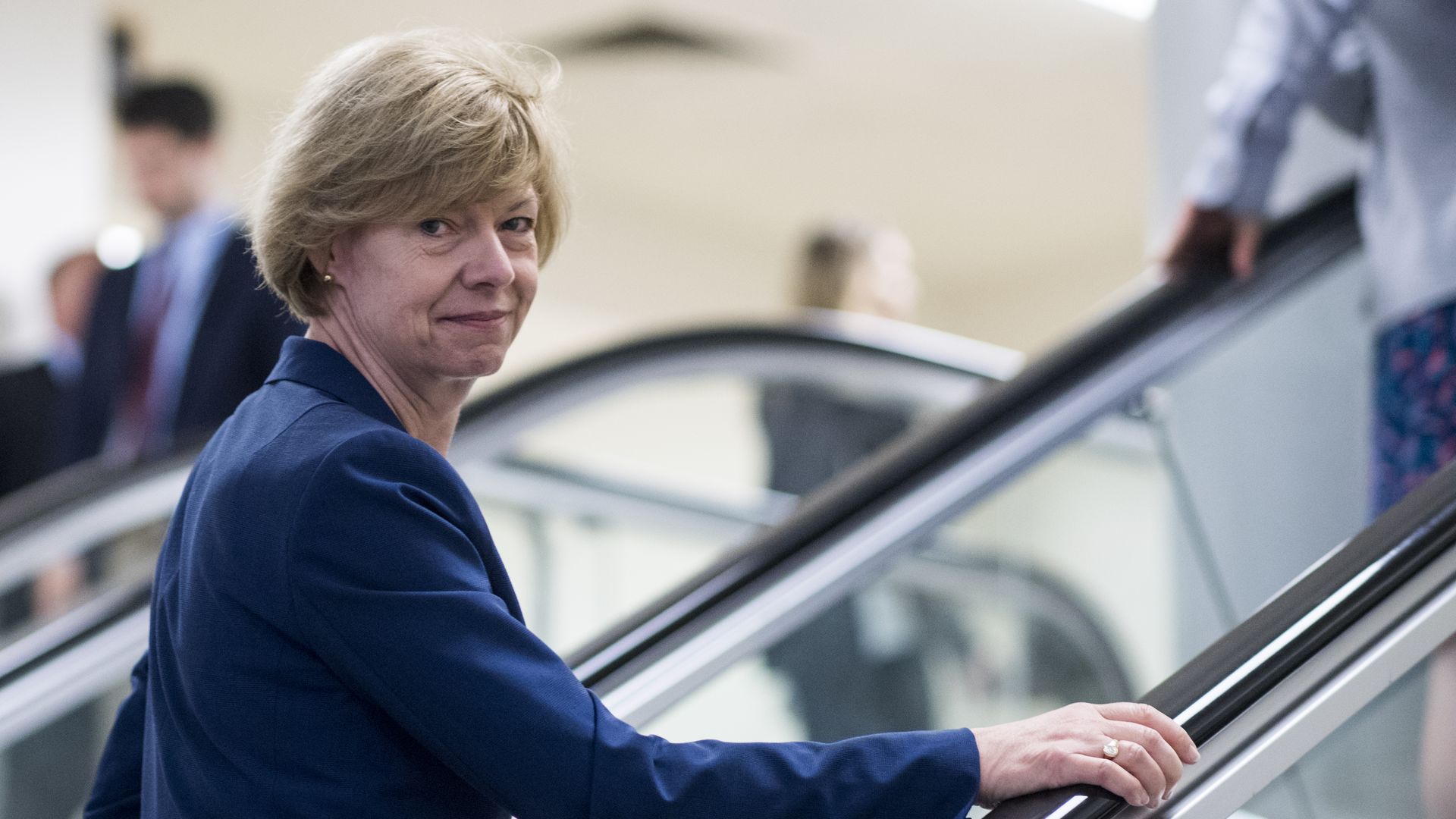 Sen. Tammy Baldwin goes up an escalator.
