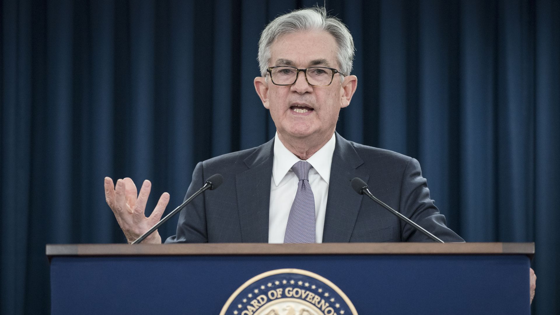 Federal Reserve chairman Jerome Powell stands at a podium at a press conference
