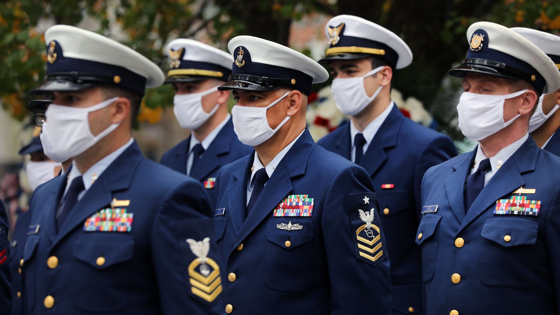 Photo of masked U.S. soldiers in their uniforms standing in formation