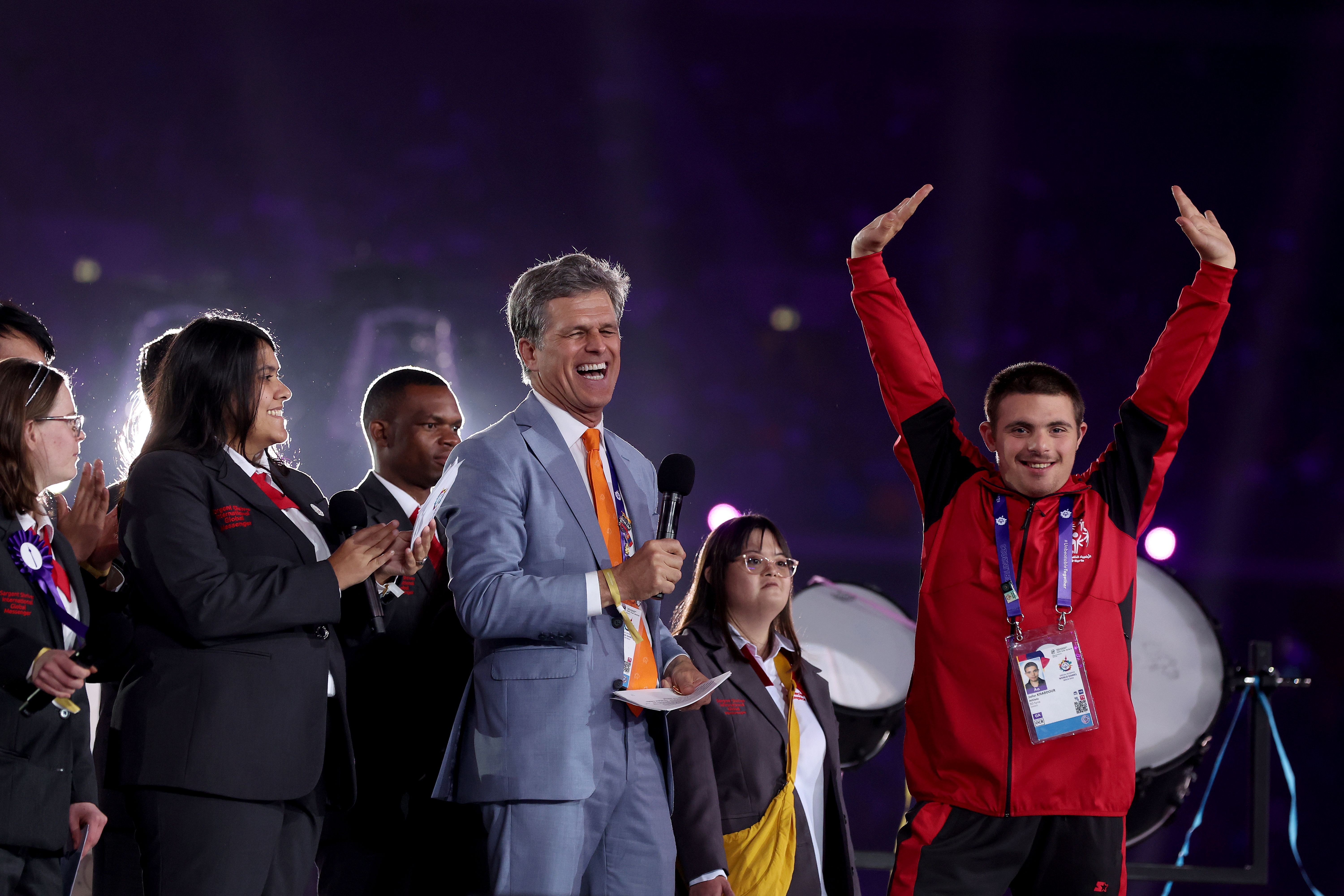 Special Olympics chairman Timothy Shriver laughs with a Syrian Athlete during his speech at the opening ceremony of the Special Olympics World Games Berlin 2023.
