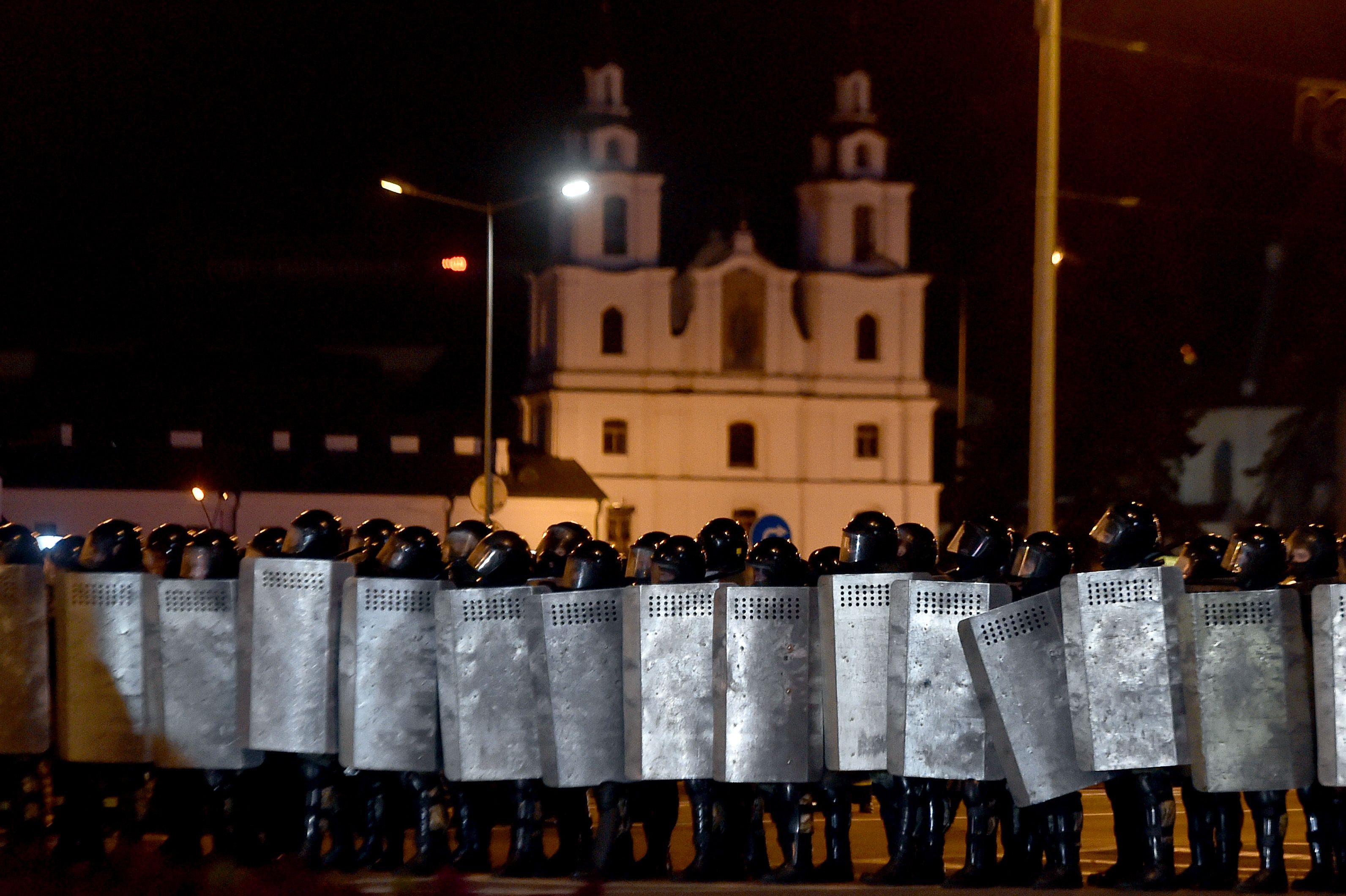 Riot police block an area after polls closed in Minsk