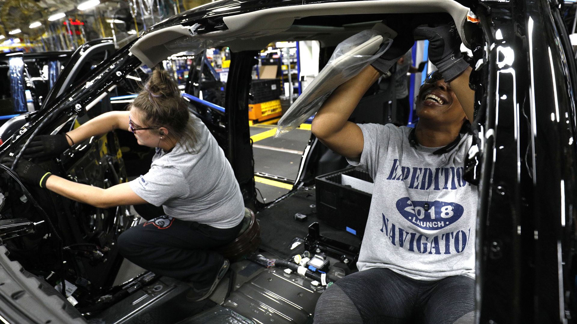 Workers in close proximity at a Ford assembly plant