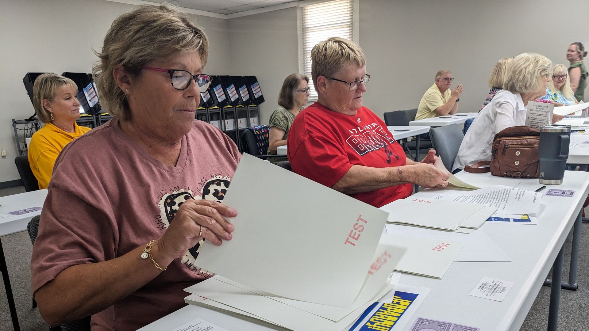 Lee County poll workers Debbie Jack (L) and Donna Mathis (R) practice counting ballots as part of new election hand count rules by the Georgia State Election Board, in Leesburg, Georgia on October 2, 2024.