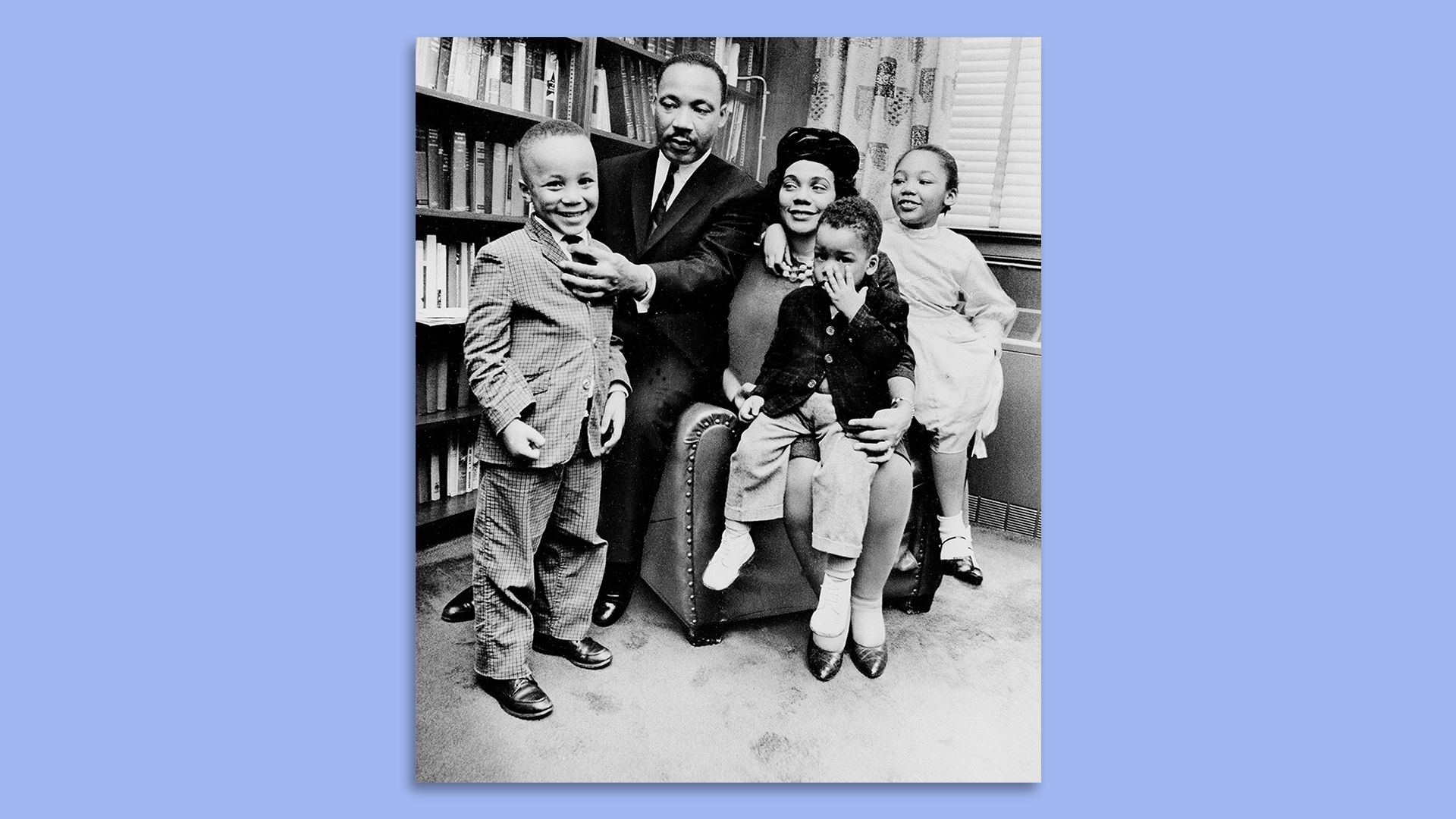 Martin Luther King Jr. adjusts his son's tie during a family portrait in their Atlanta home