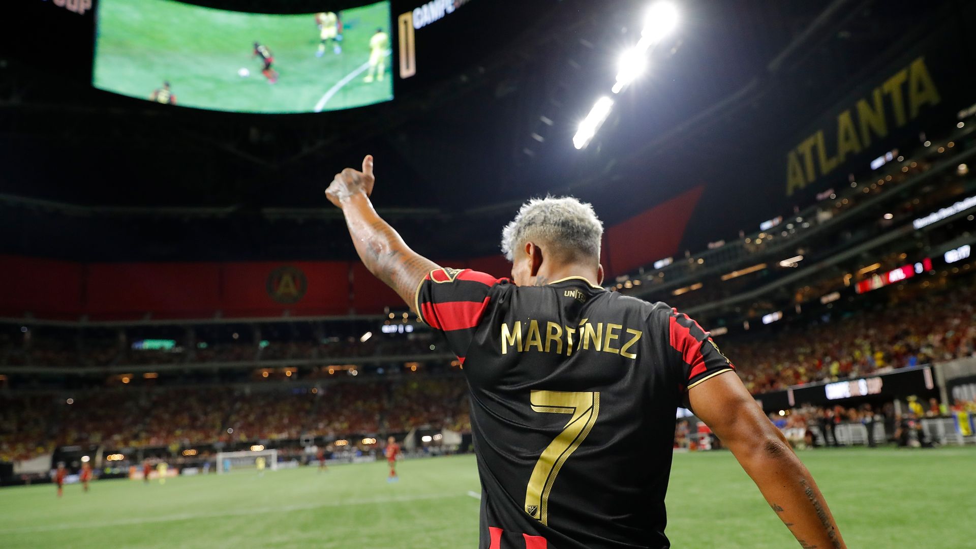 A view of Josef Martinez giving a thumbs up the players on the field at a soccer game