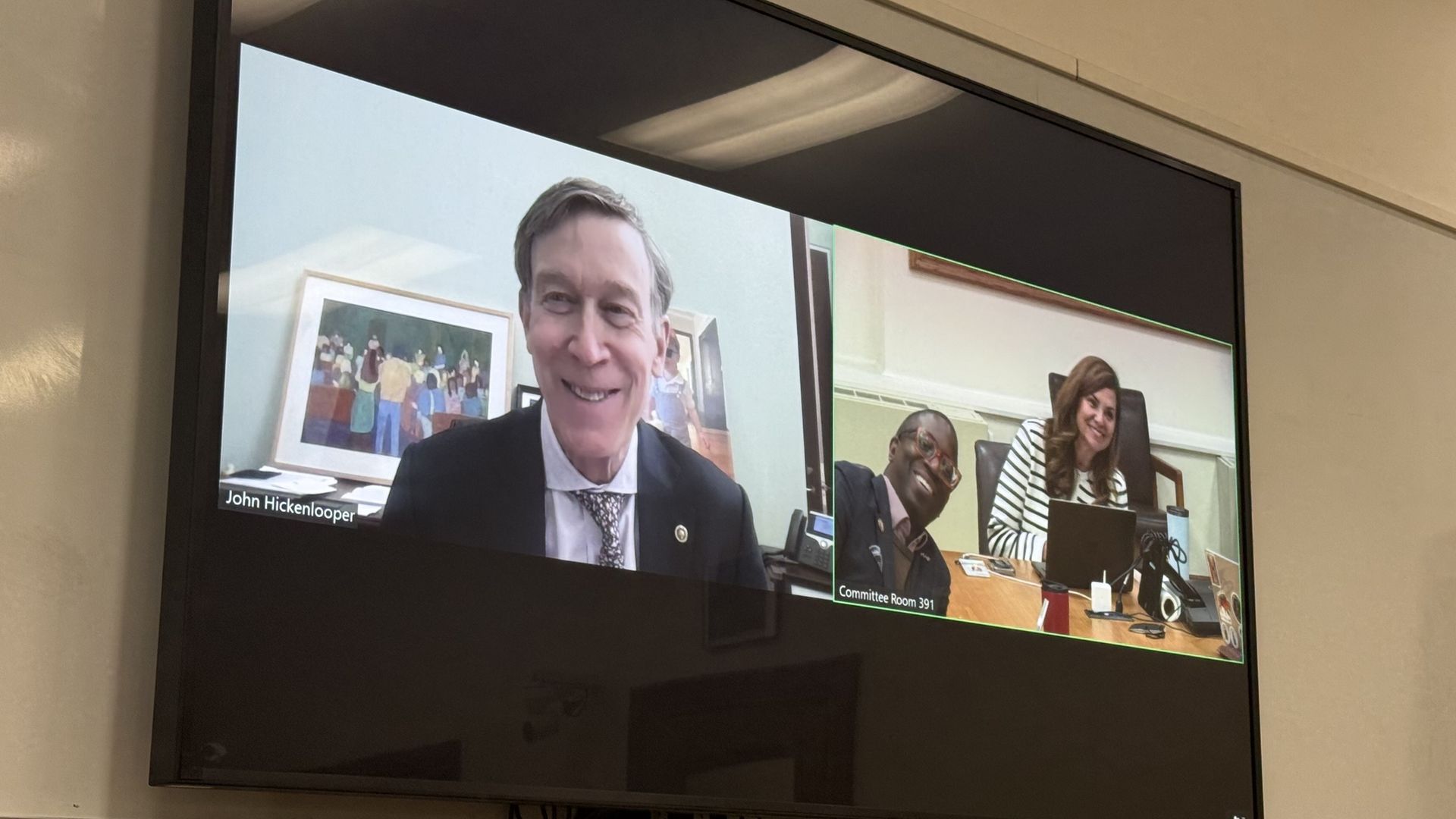 Three people on a split screen smile. 