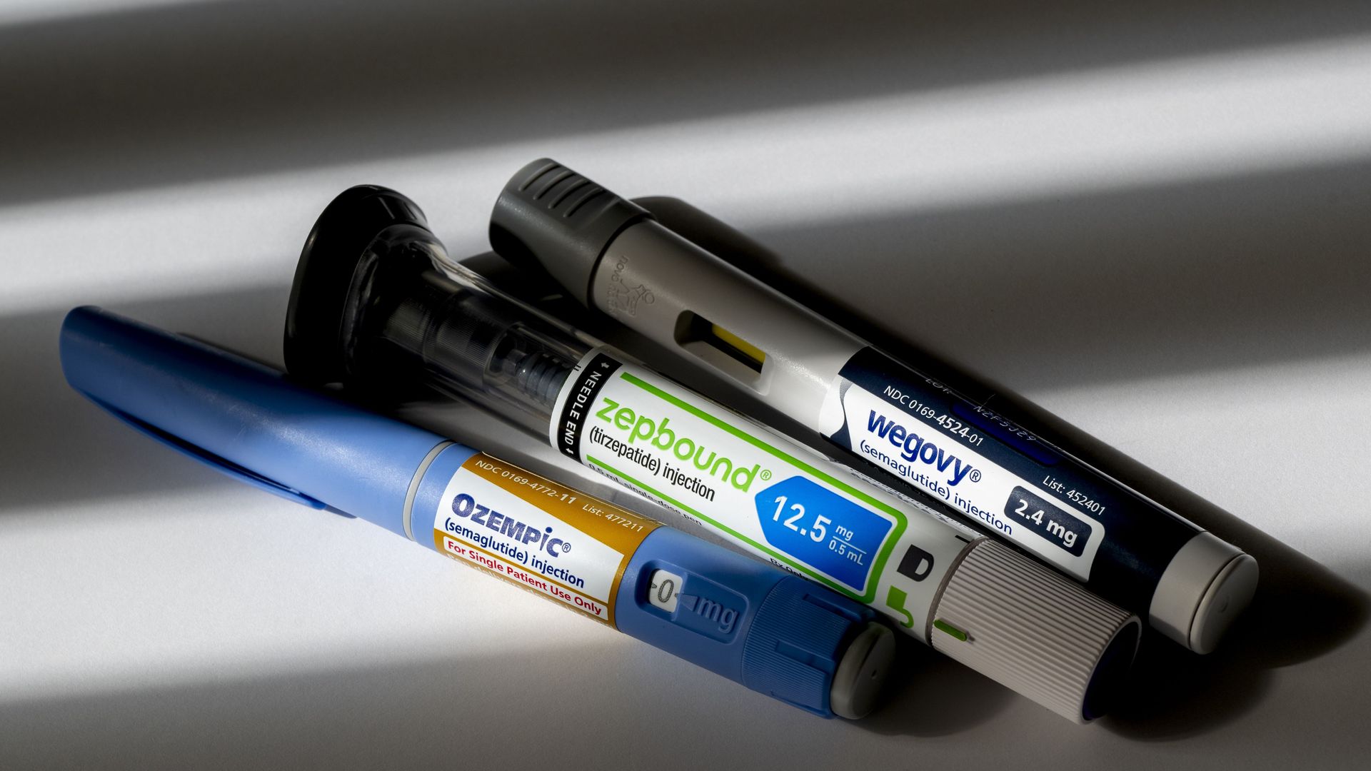 A group of weight loss injection pens arranged for a photo illustration.