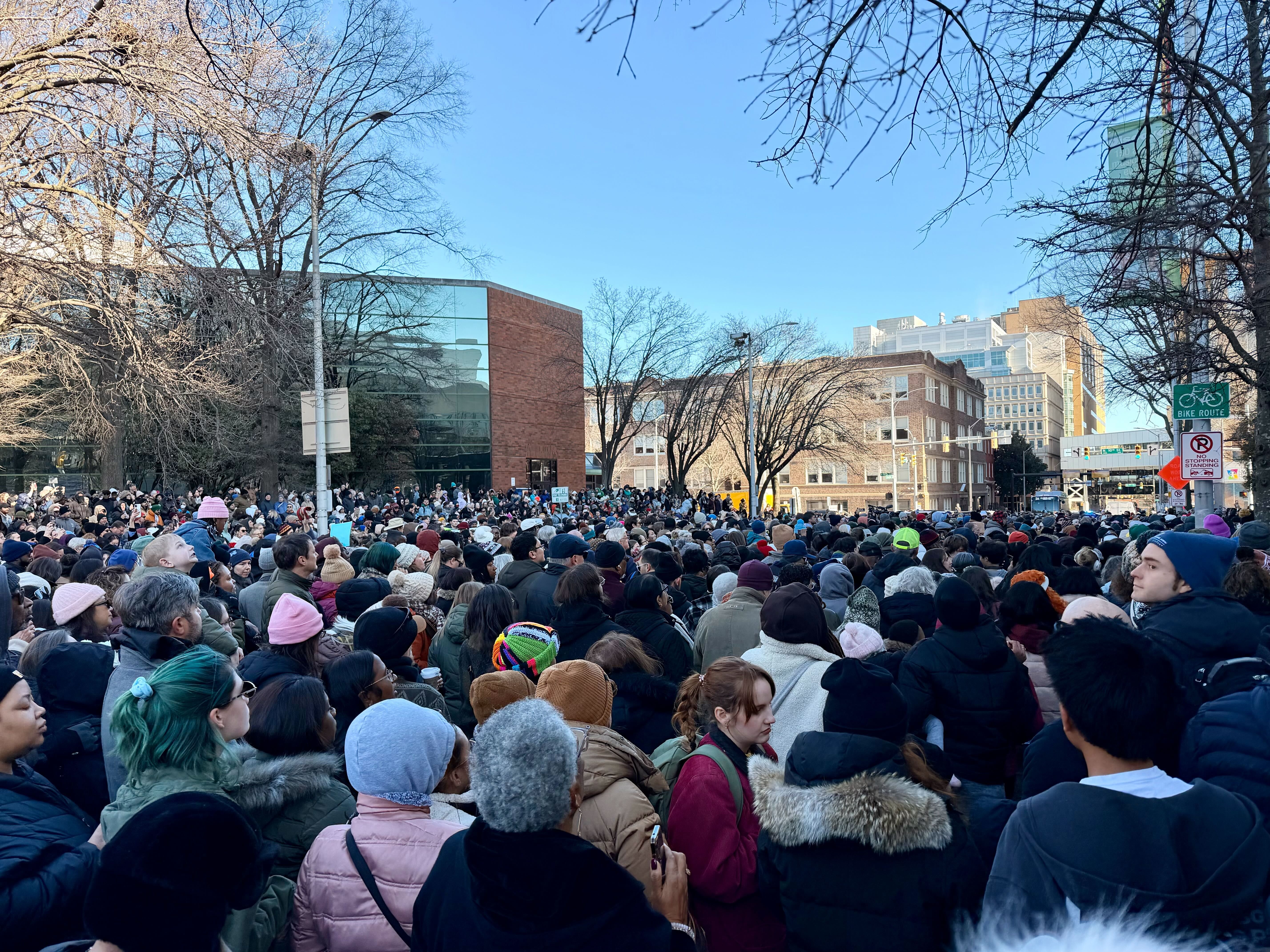 a massive crowd of people around city hall 
