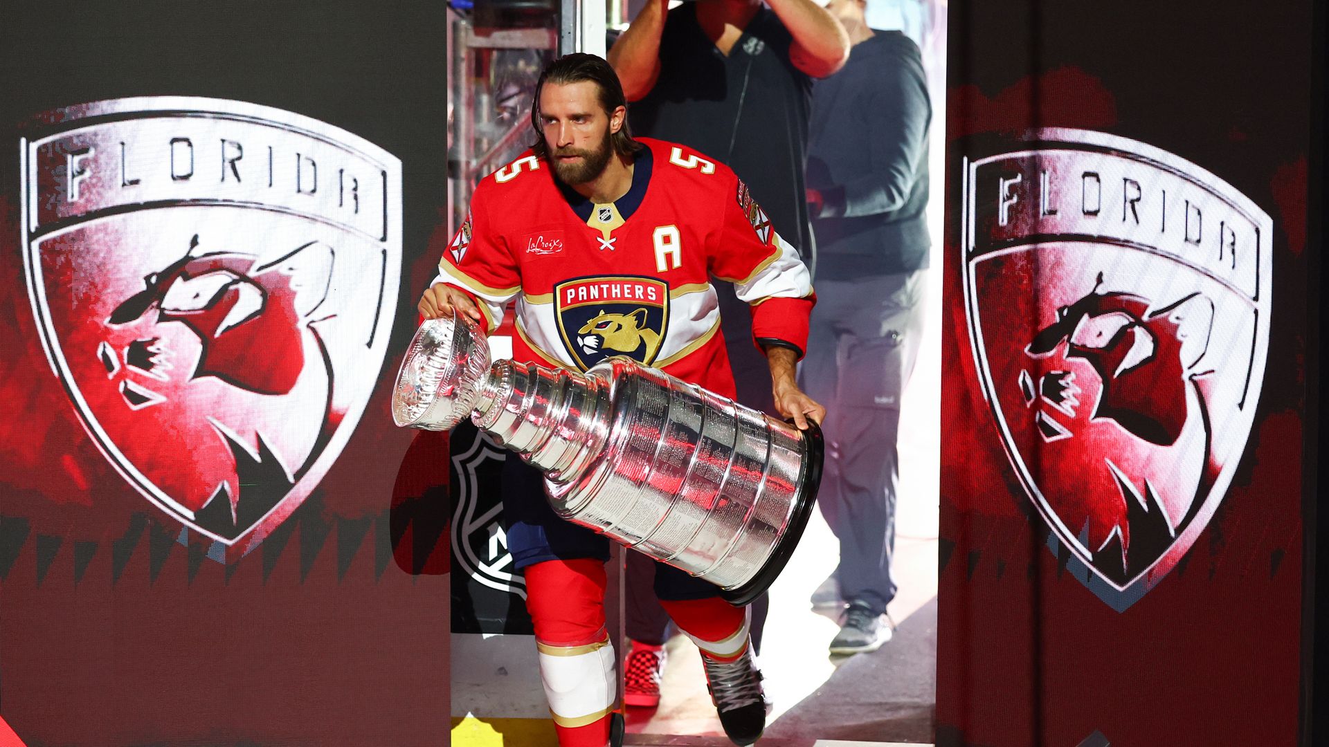 SUNRISE, FLORIDA - OCTOBER 07: Aaron Ekblad #5 of the Florida Panthers lifts the Stanley Cup on the ice during a ceremony before the Florida Panthers' home opener against the Chicago Blackhawks at Amerant Bank Arena on October 07, 2025 in Sunrise, Florida. (Photo by Megan Briggs/Getty Images)
