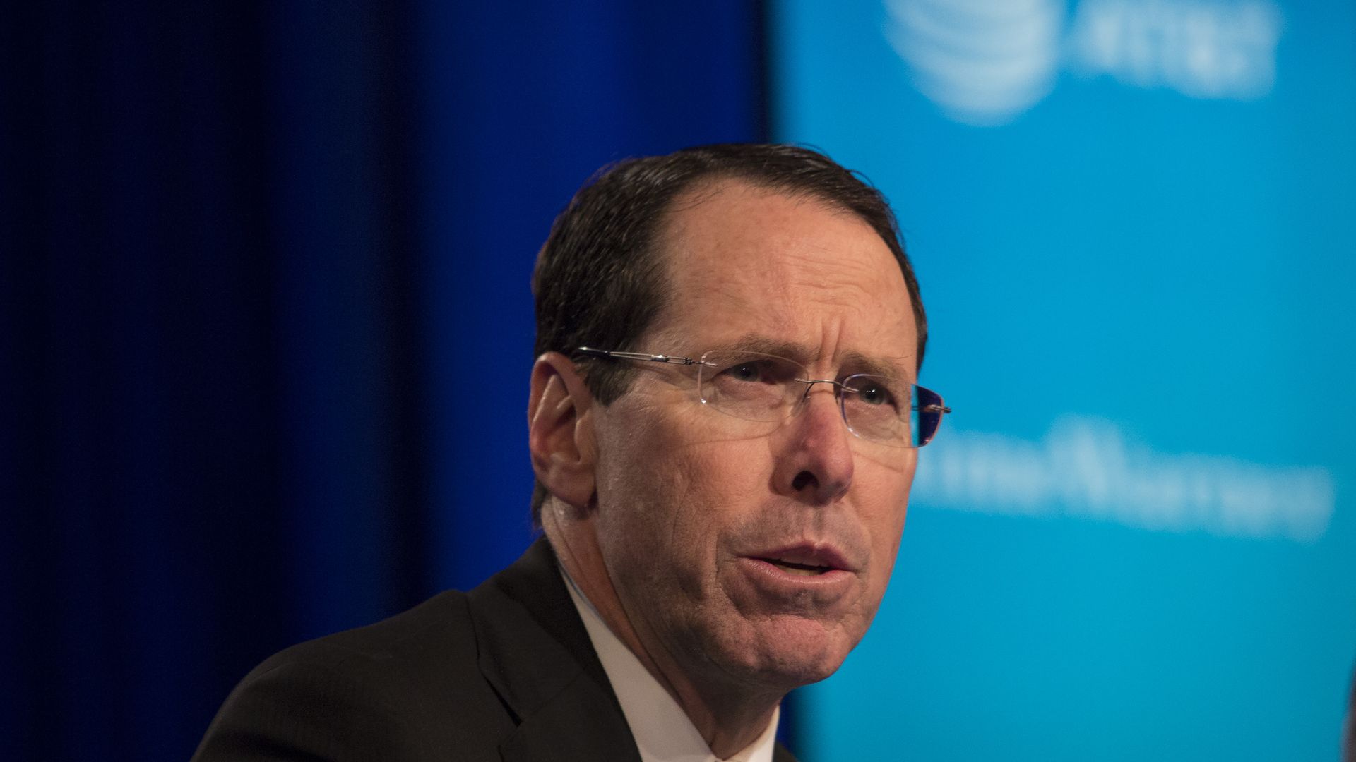 Randall Stephenson in front of a blue backdrop