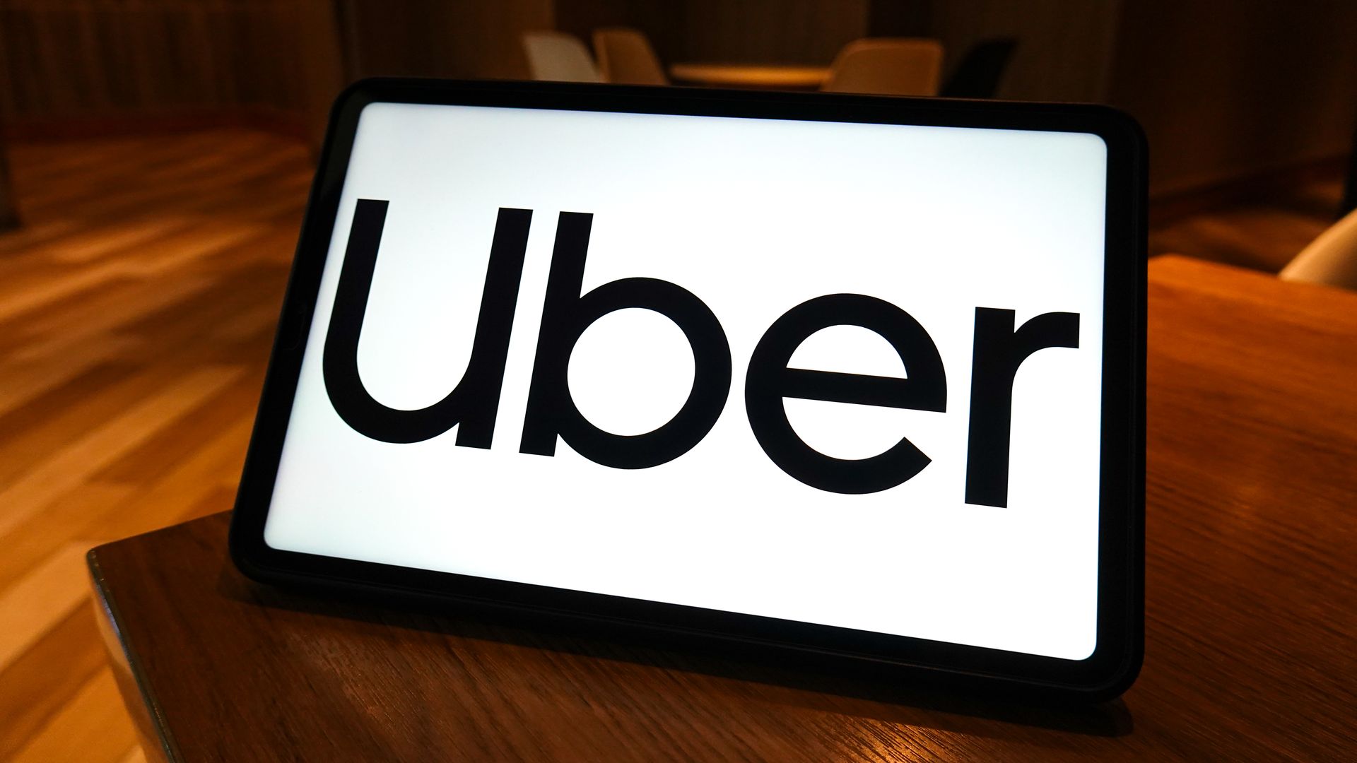 In this photo illustration, the logo of Uber is displayed on the screen of a smart tablet. 