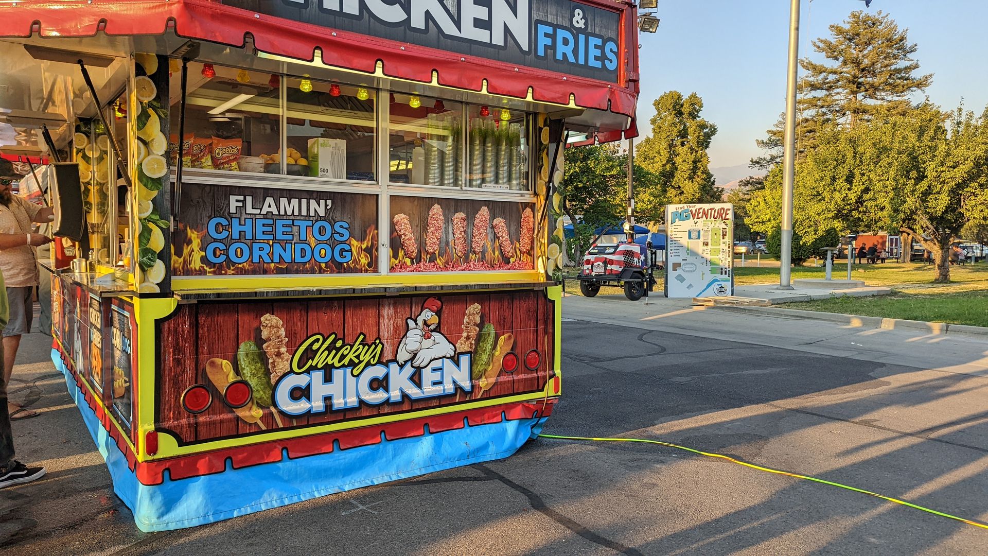 A carnival food vendor advertises Flamin' Cheetos Corndogs.