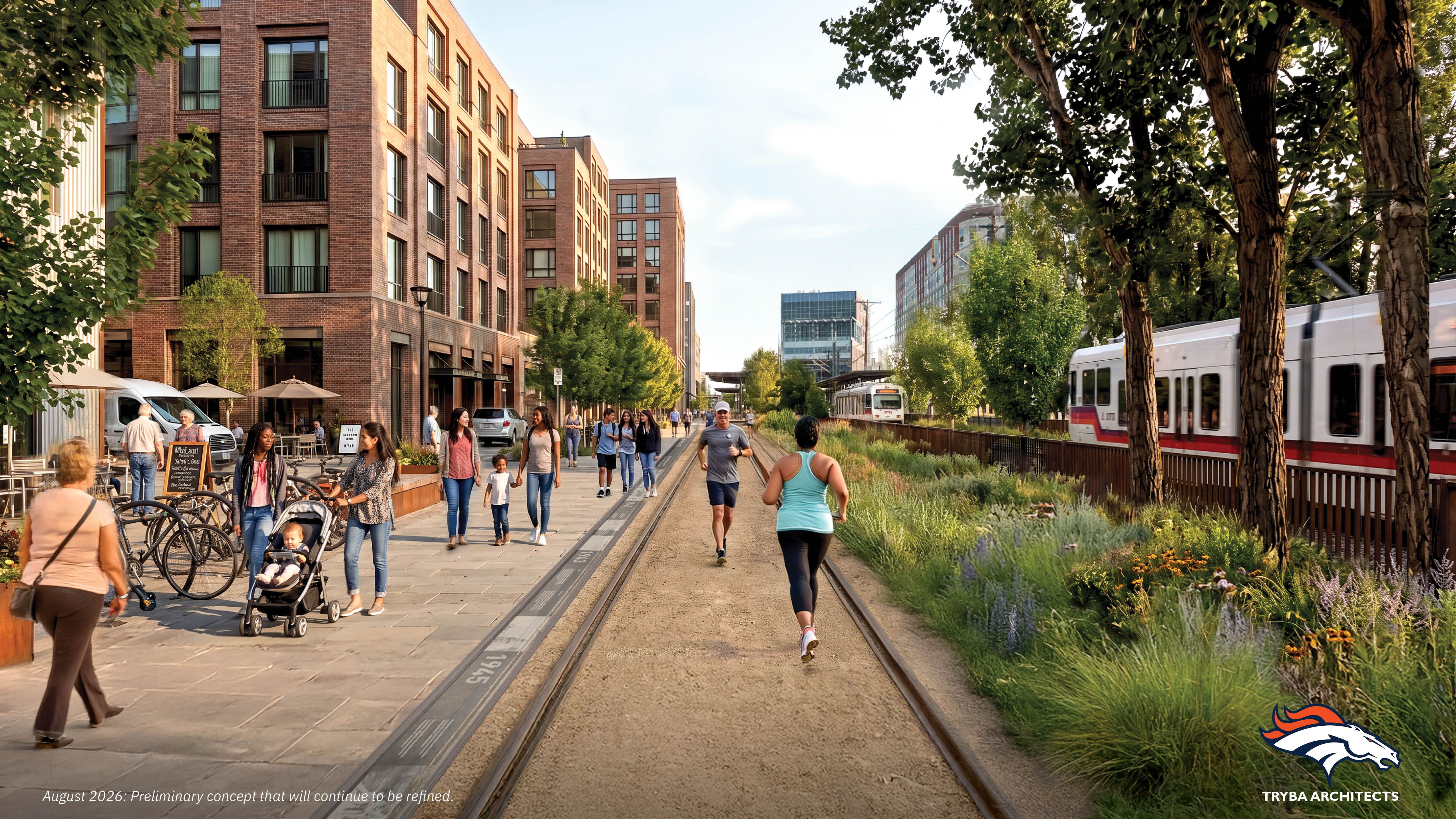 Urban streetscape with red brick mid-rise buildings on the left, parallel tram tracks in the center, pedestrians and cyclists on a wide sidewalk, a train on the right, and trees framing the scene.