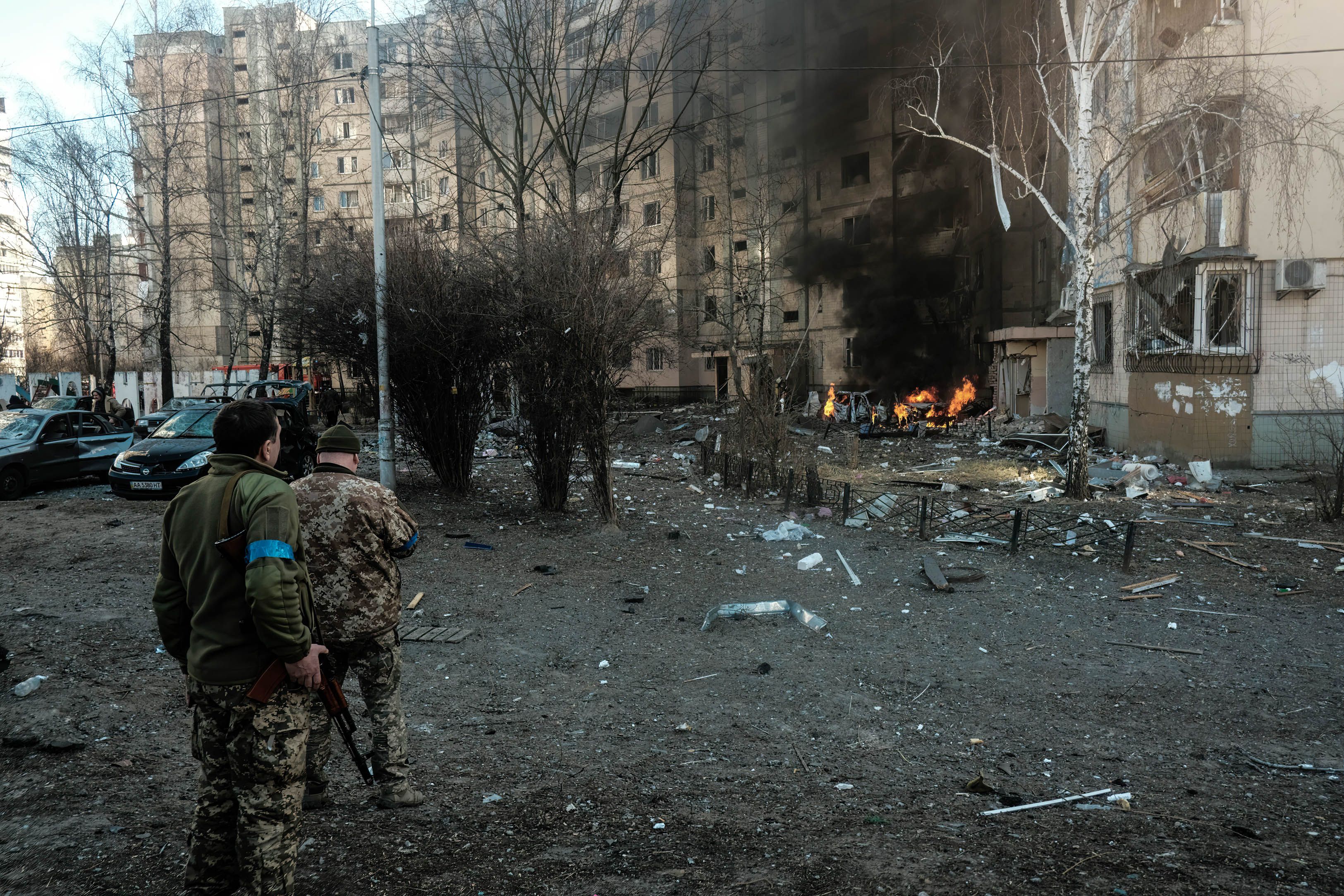 Soldiers and police examine the aftermath of a missile landing near a residential building after being shot out of the sky in the Bilychi neighborhood in Kyiv. 