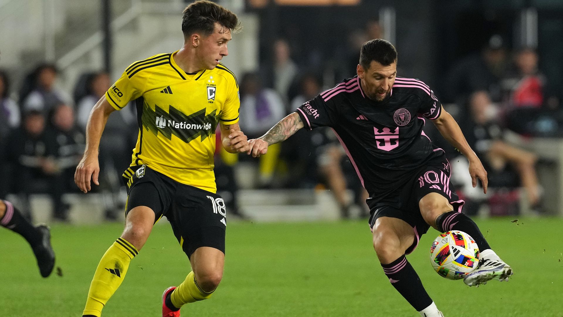 Lionel Messi of Inter Miami CF controls the ball against Malte Amundsen of the Columbus Crew