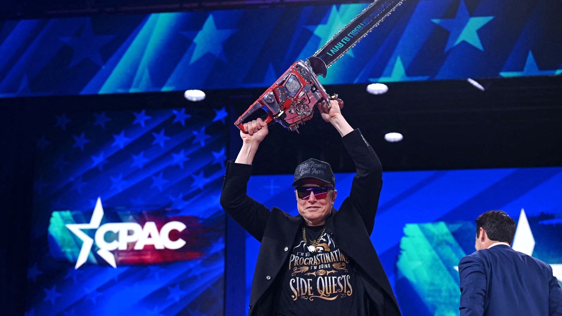 Elon Musk holds a chainsaw reading "Long live freedom, damn it" during the annual Conservative Political Action Conference in Oxon Hill, Md., on Feb. 20, 2025. 