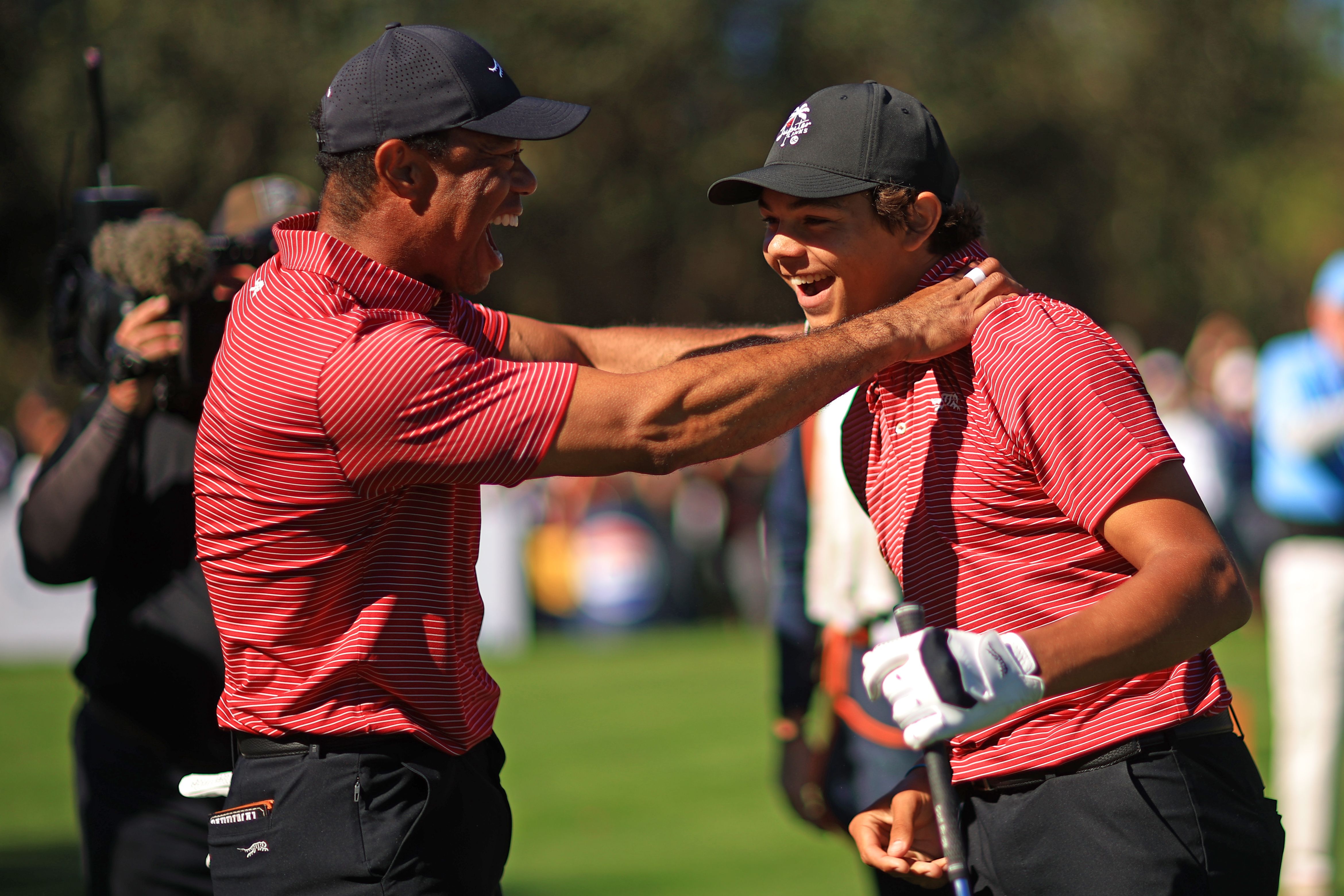 Tiger Woods reacts after his son Charlie (right) shot a hole-in-one during the PNC Championship in Orlando yesterday.