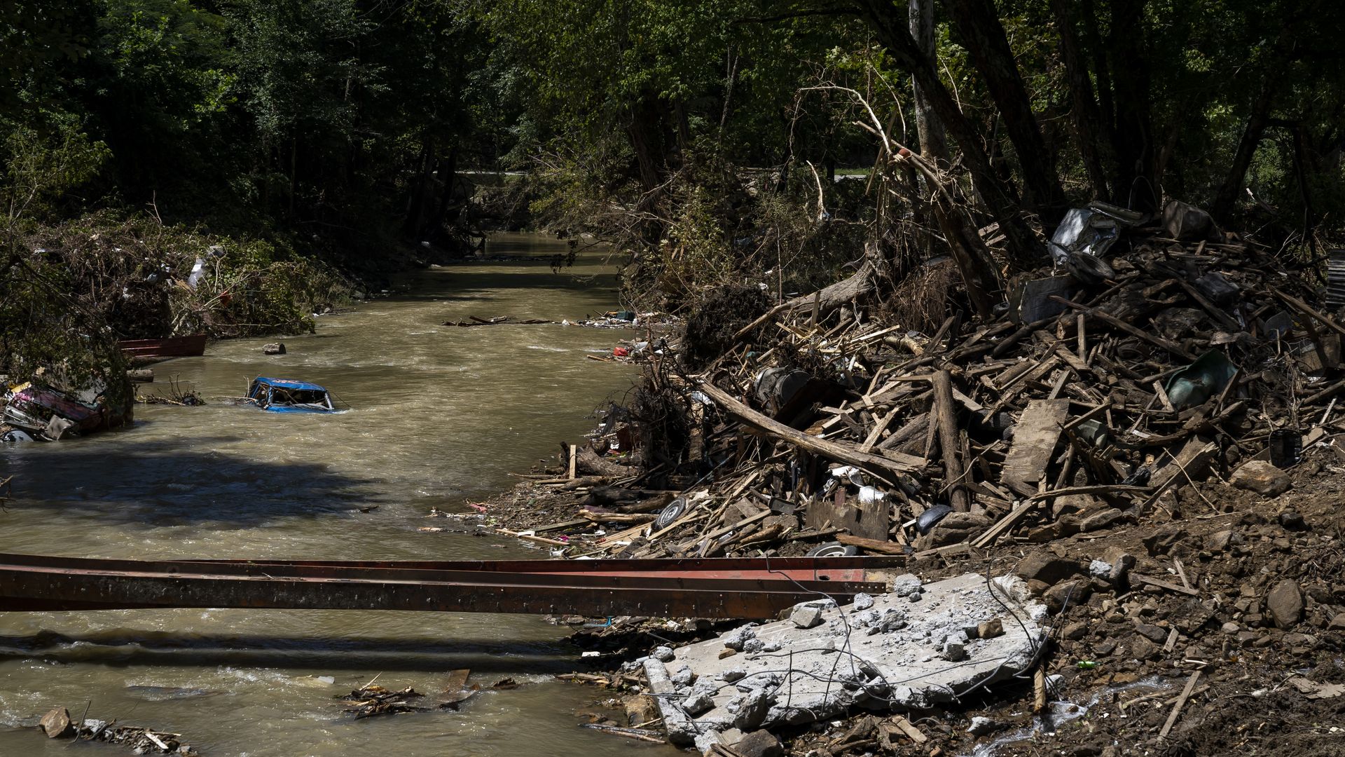 A car is still partially submerged in Troublesome Creek in Perry County, Kentucky near Hazard on August 6.