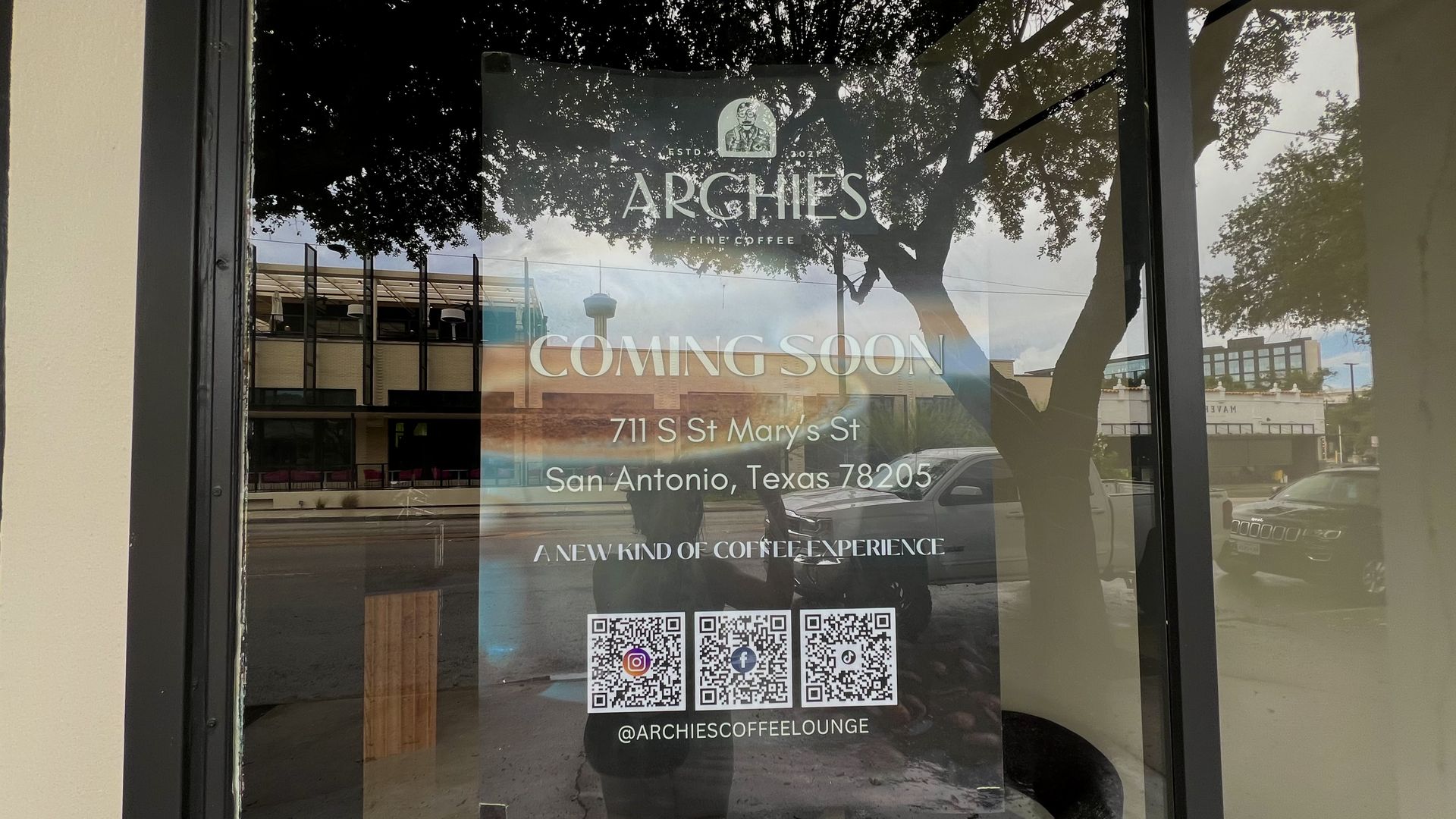 Window poster for Archie's Fine Coffee at 711 S St Mary's St, San Antonio, Texas 78205, announcing "COMING SOON" with QR codes and social media @ARCHIESCOFFEELOUNGE.