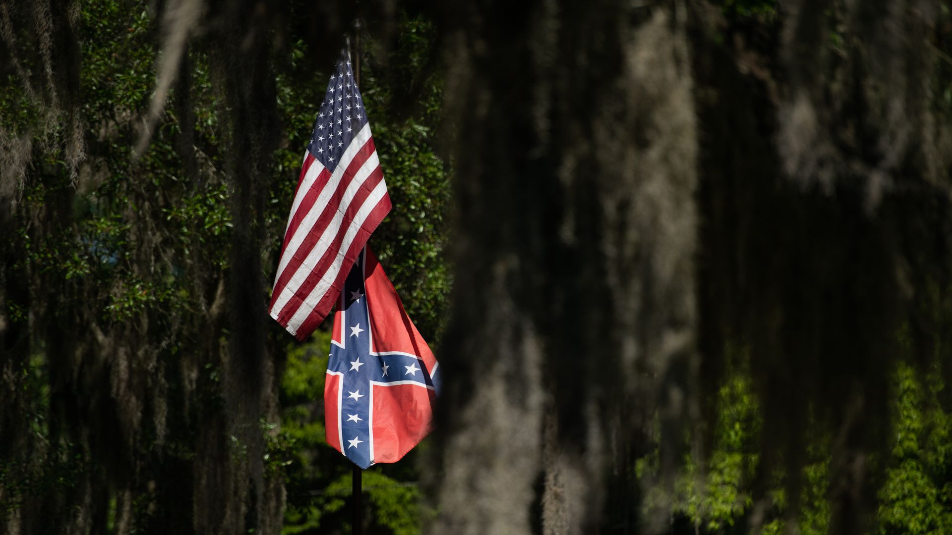American and Confederate flags fly at a residence in the Fancy Bluff neighborhood on May 7