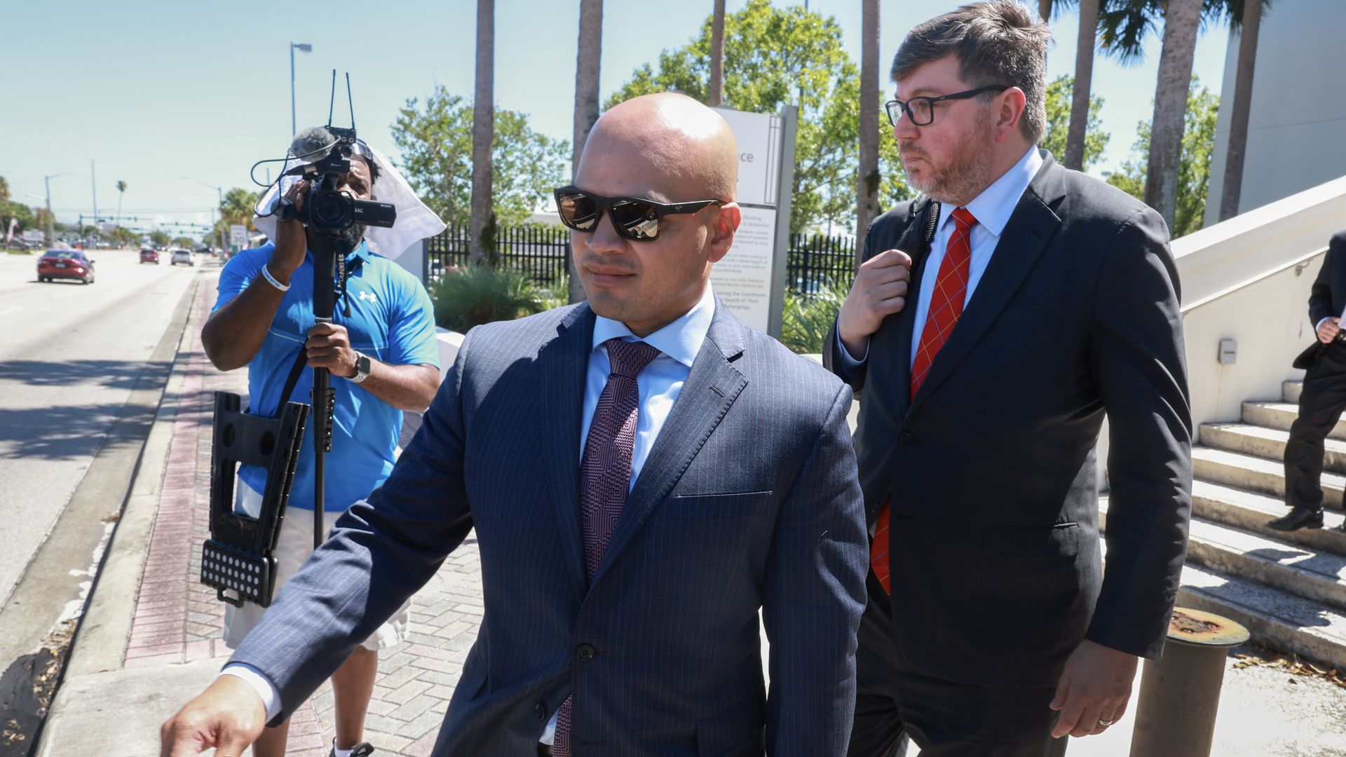 Walt Nauta (L), an aide to former U.S. President Donald Trump, walks with his lawyer Stanley Woodward (R) as they leave the Alto Lee Adams Sr United States Courthouse on May 22, 2024 in Fort Pierce, Florida. 