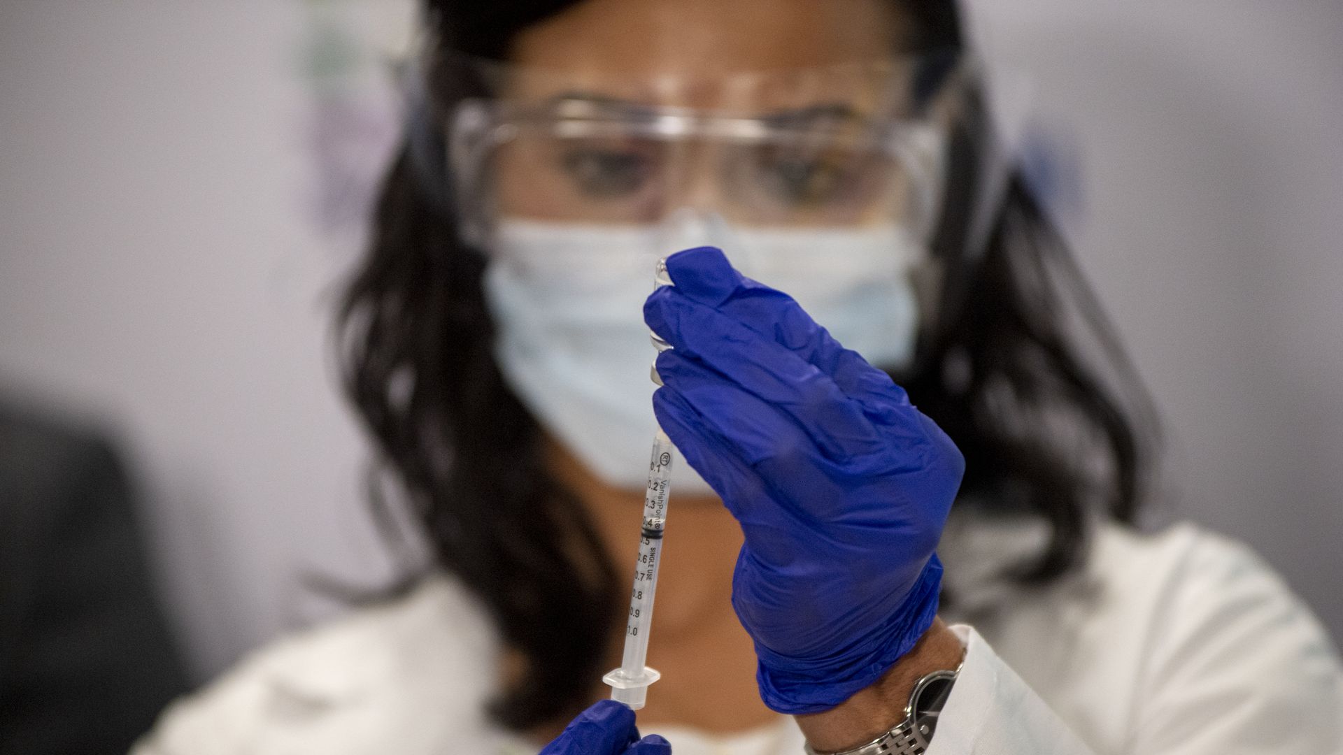 A healthcare worker prepares a dose of a Covid-19 vaccine 