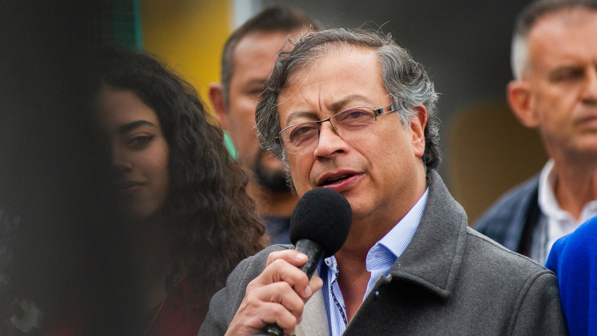 Colombian President-elect Gustavo speaks while holding a black microphone in his hand.