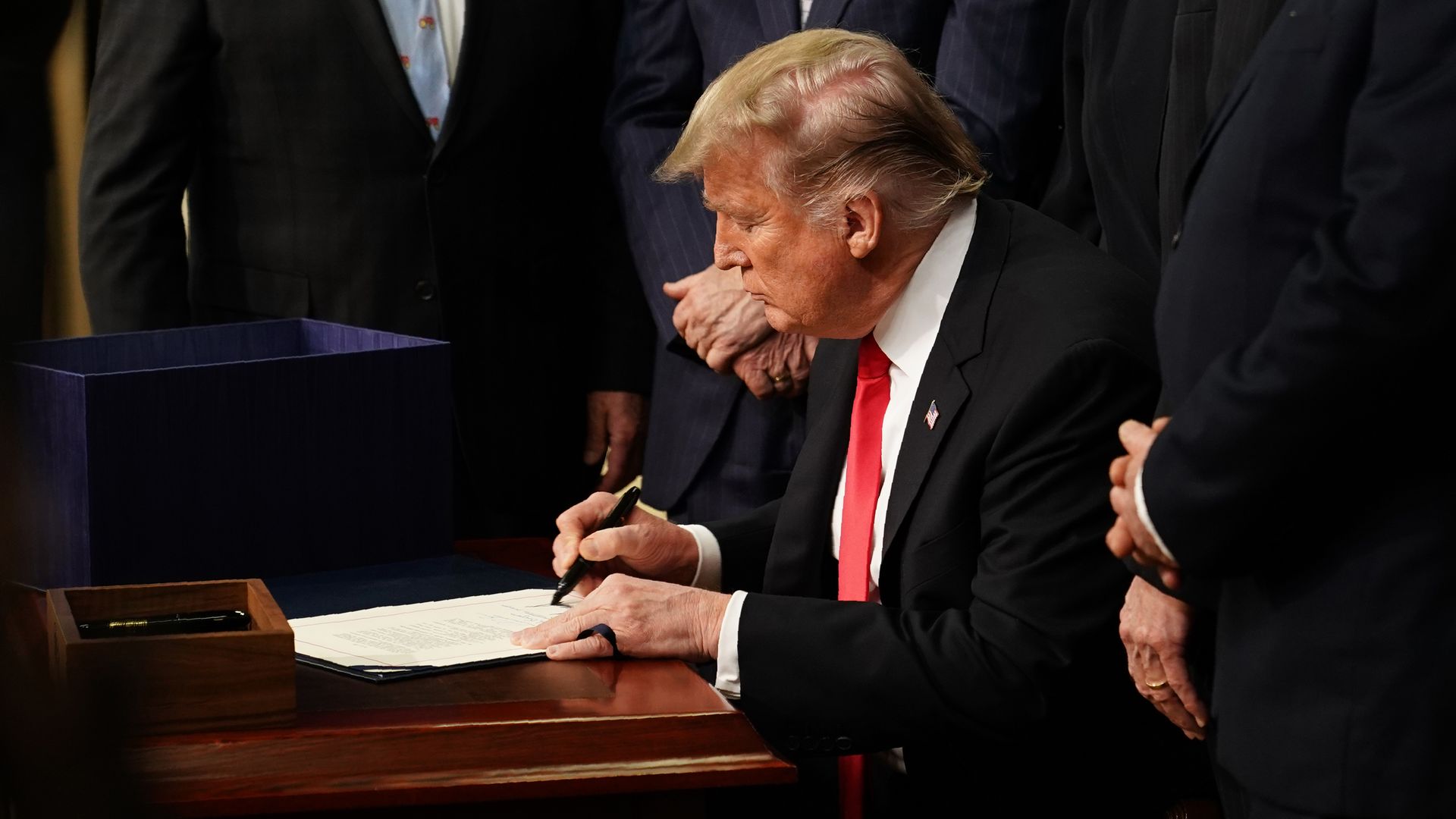 Donald Trump signing a bill. 