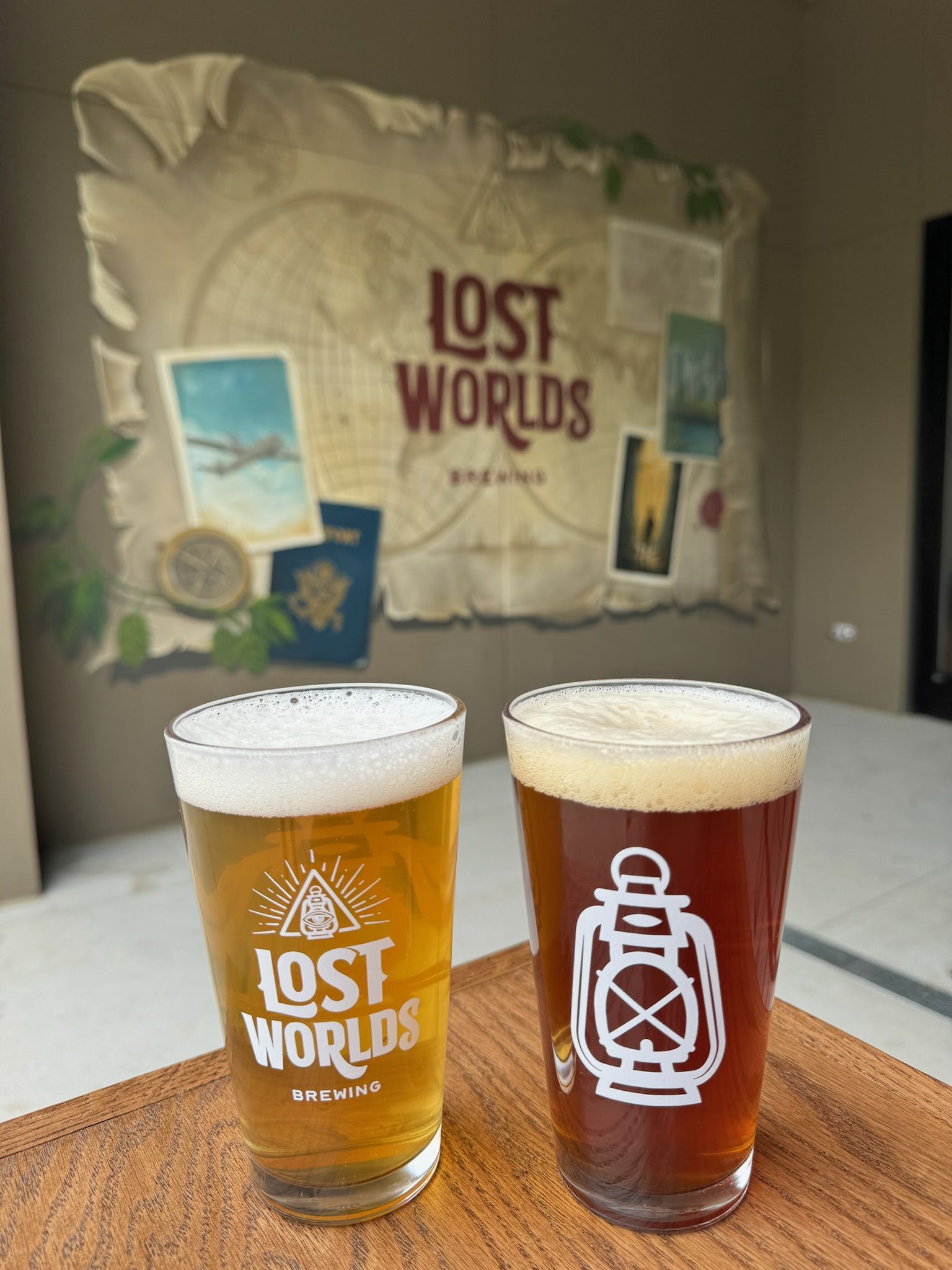 two beer glasses reading "lost worlds"