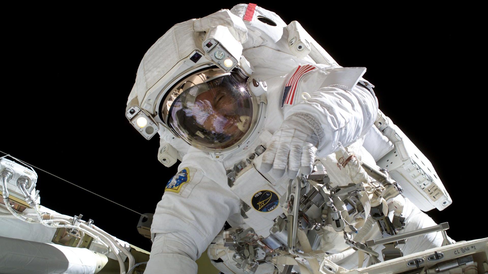 An astronaut outside of the ISS in a spacesuit