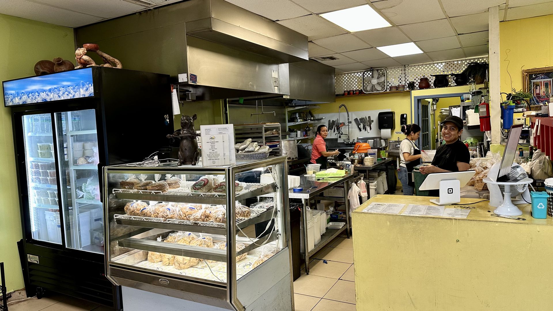 Photo shows workers in an open kitchen