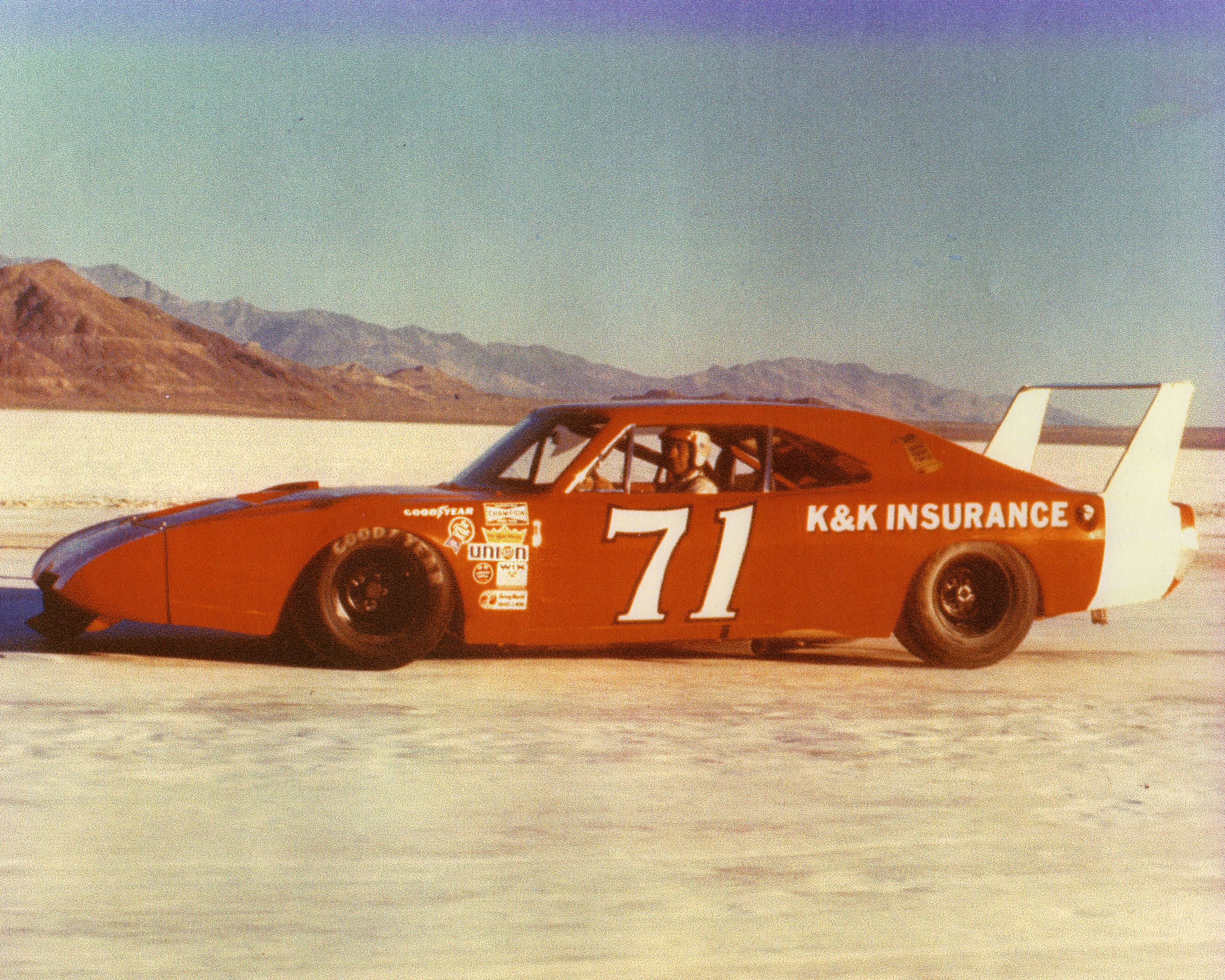 A red race car with the No. 71, sitting on the salt flats.