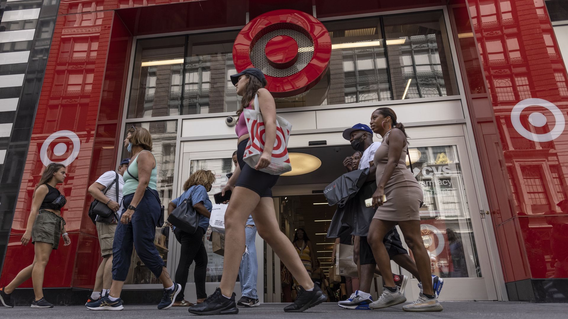 Shoppers walk past a Target store