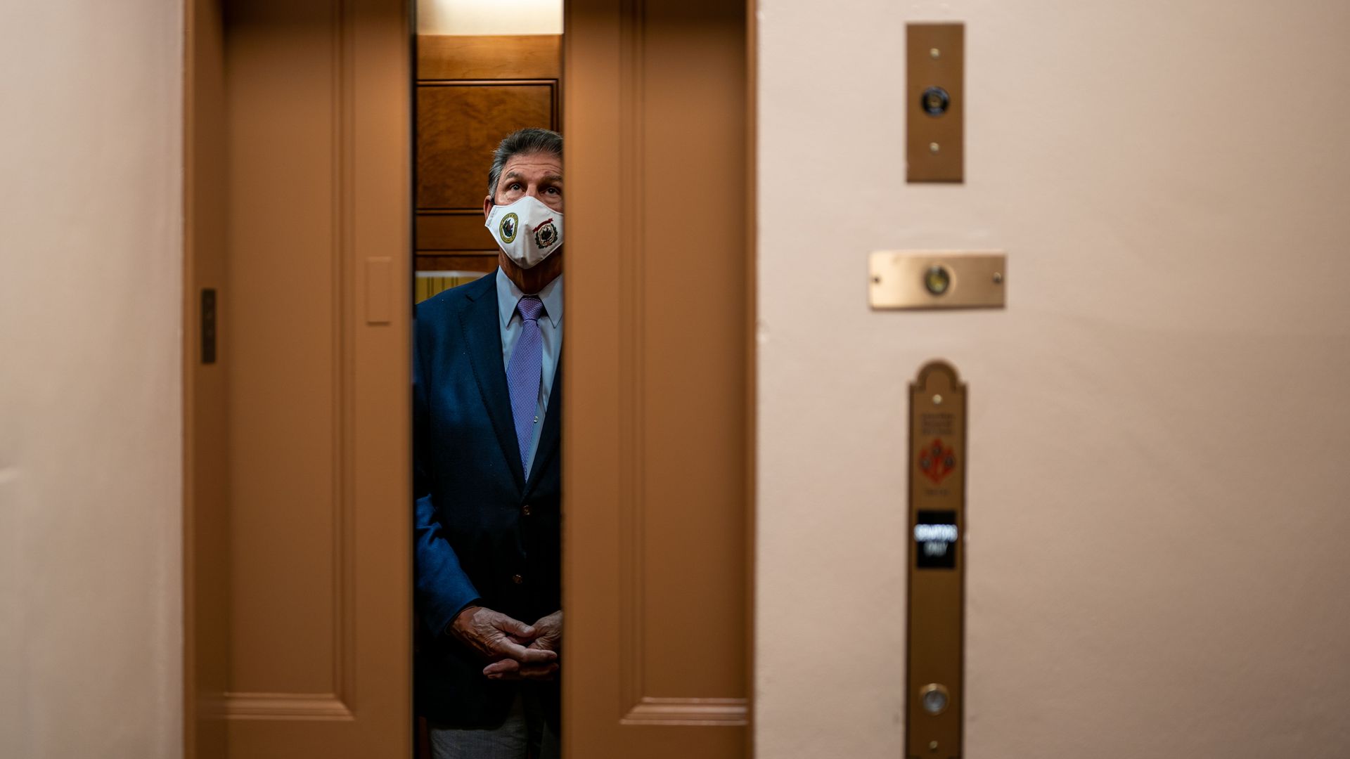 An elevator door at the Capitol is closing with Sen. Joe Manchin inside