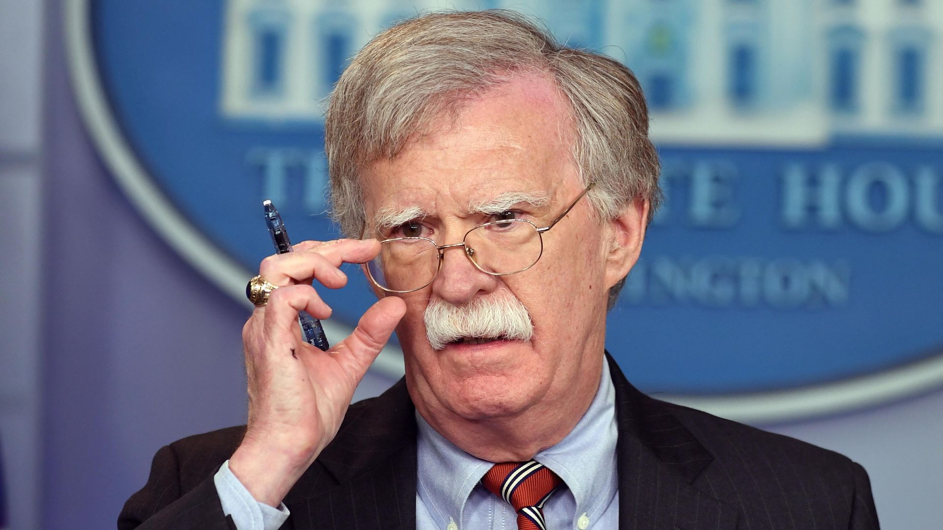 In this image, Bolton adjusts his glasses.